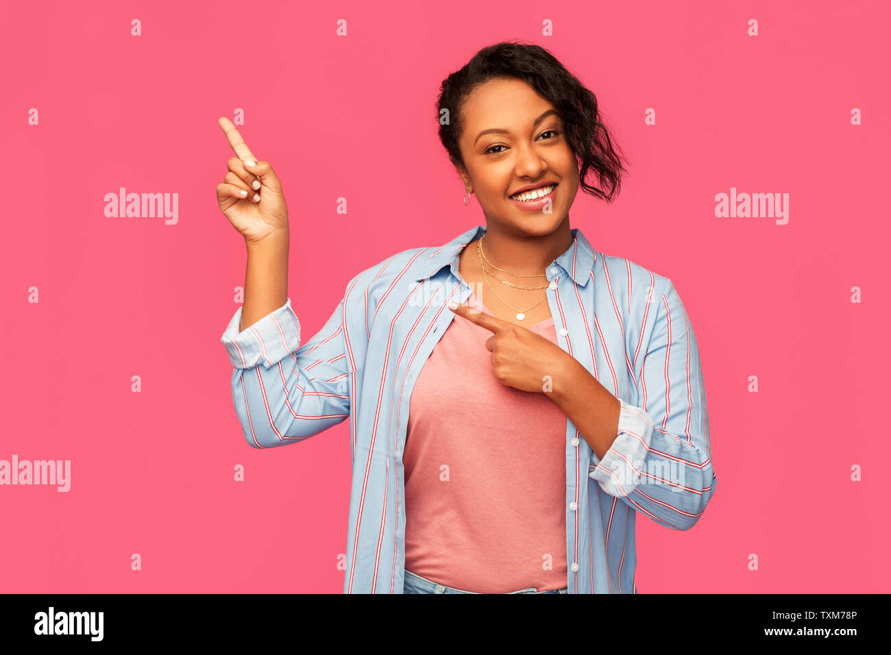 happy african american woman pointing finger up Stock Photo - Alamy