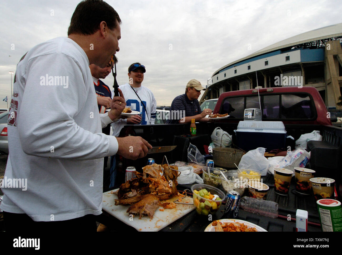 Rowdy Horn checks the turkey he is deep frying for Thanksgiving dinner  during pre-game tailgating for the Dallas Cowboys-Seattle Seahawks game  November 27, 2008 at Texas Stadium in Irving, Texas. Since 1978