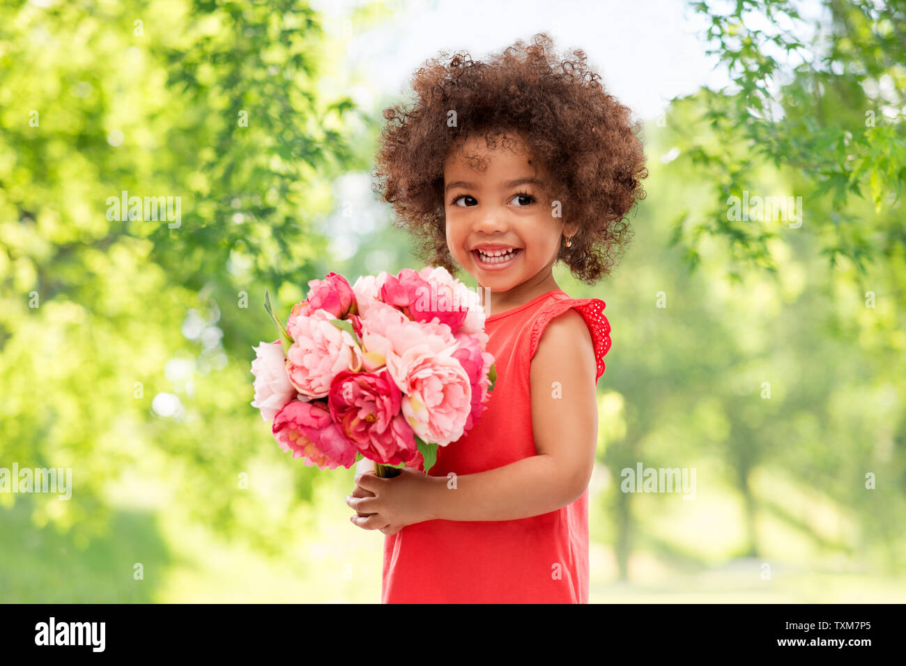 happy little african american girl with flowers Stock Photo - Alamy