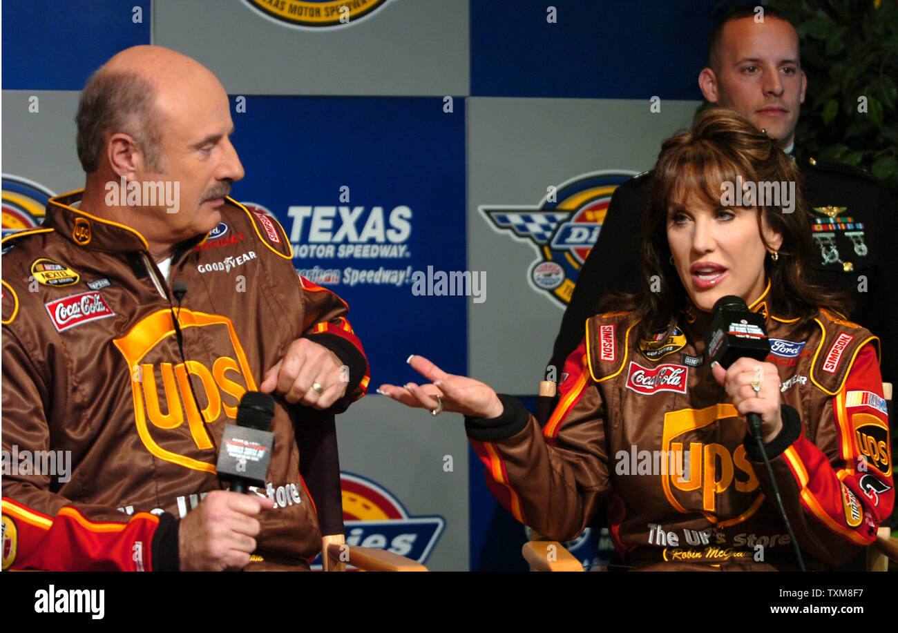 Dr. Phil McGraw, and his wife Robin, talk to the media about the U.S. Marine Corps Reserves Toys for Tots program prior to the NASCAR Dickies 500 at Texas Motor Speedway in Ft. Worth, TX on November 5, 2006.  The McGraw's teamed up with NASCAR to help raise awareness of the program.    (UPI Photo/Ian Halperin) Stock Photo