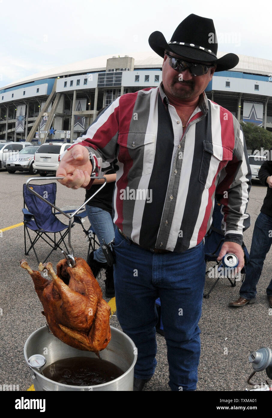Rowdy Horn checks the turkey he is deep frying for Thanksgiving dinner during pre game tailgating for the Dallas Cowboys Seattle Seahawks game November 27 2008 at Texas Stadium in Irving Texas. Since ...