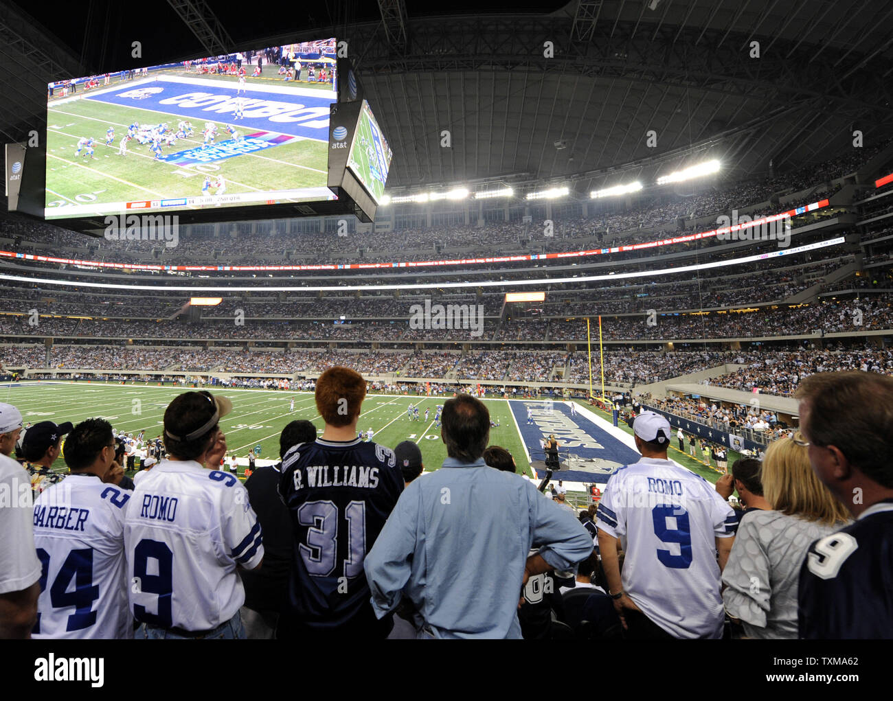 Fans watch the Dallas Cowboys battle the New York Giants on the stadium's giant video scoreboard September 21, 2009 in Arlington, Texas.   More than 100,000 fans filled the new $1.2 billion stadium for the first NFL game.   UPI/Ian Halperin Stock Photo