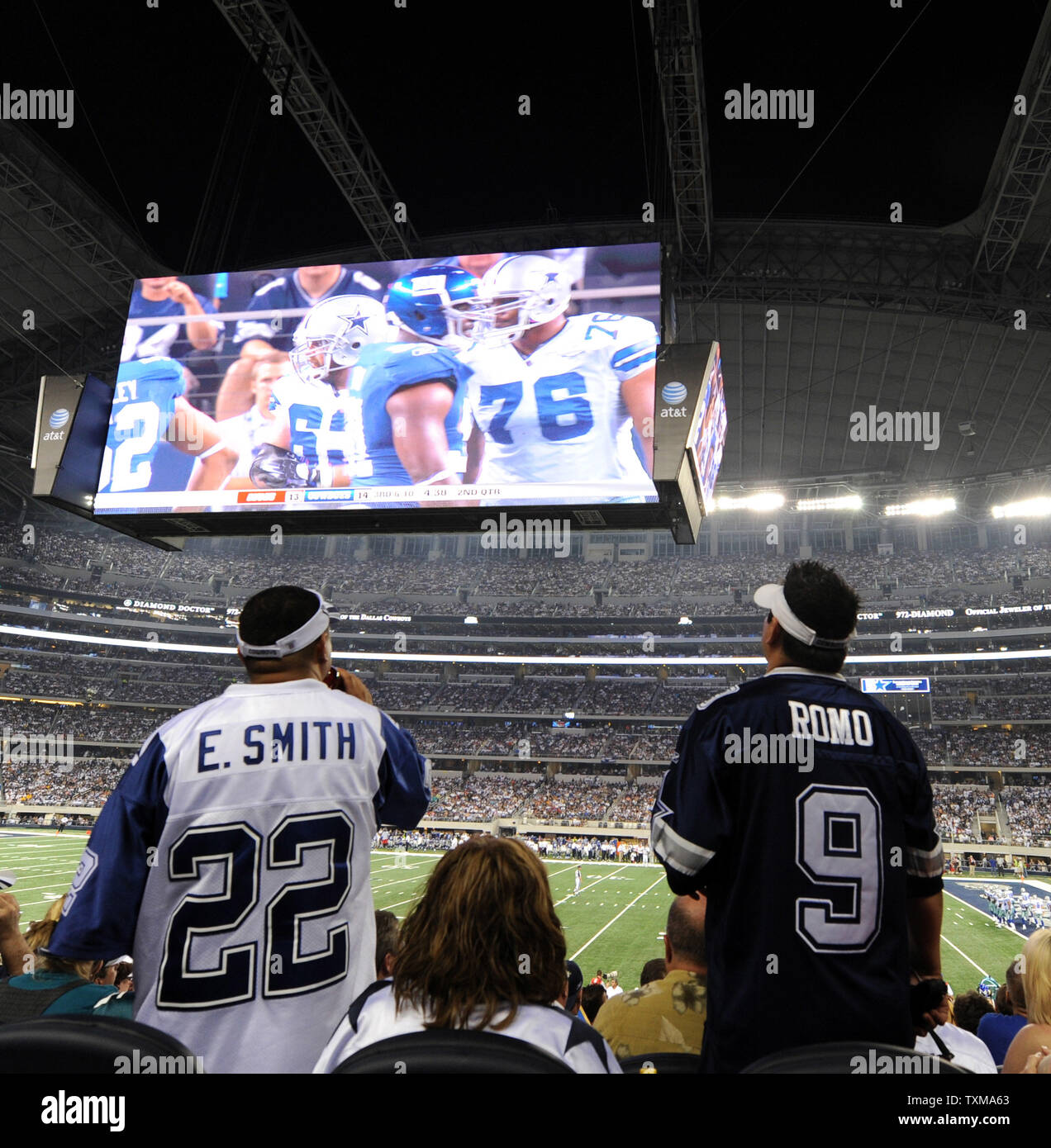 Fans watch the Dallas Cowboys battle the New York Giants on the stadium's giant video scoreboard September 21, 2009 in Arlington, Texas.   More than 100,000 fans filled the new $1.2 billion stadium for the first NFL game.   UPI/Ian Halperin Stock Photo