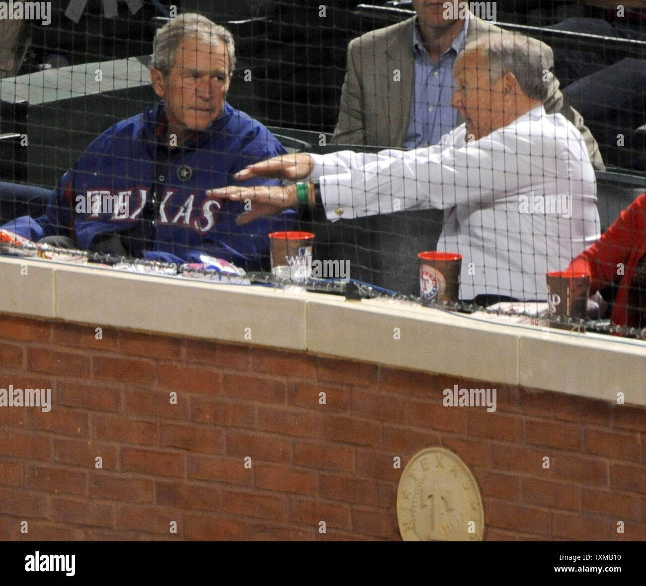 Texas Rangers' owner Nolan Ryan talks with former President George W. Bush as the Rangers battle the San Francisco Giants in game 3 of the World Series at Rangers Ballpark in Arlington, Texas on October 20, 2010.  The Rangers won 4-2 and trail 2-1 in the series.  UPI/Ian Halperin Stock Photo