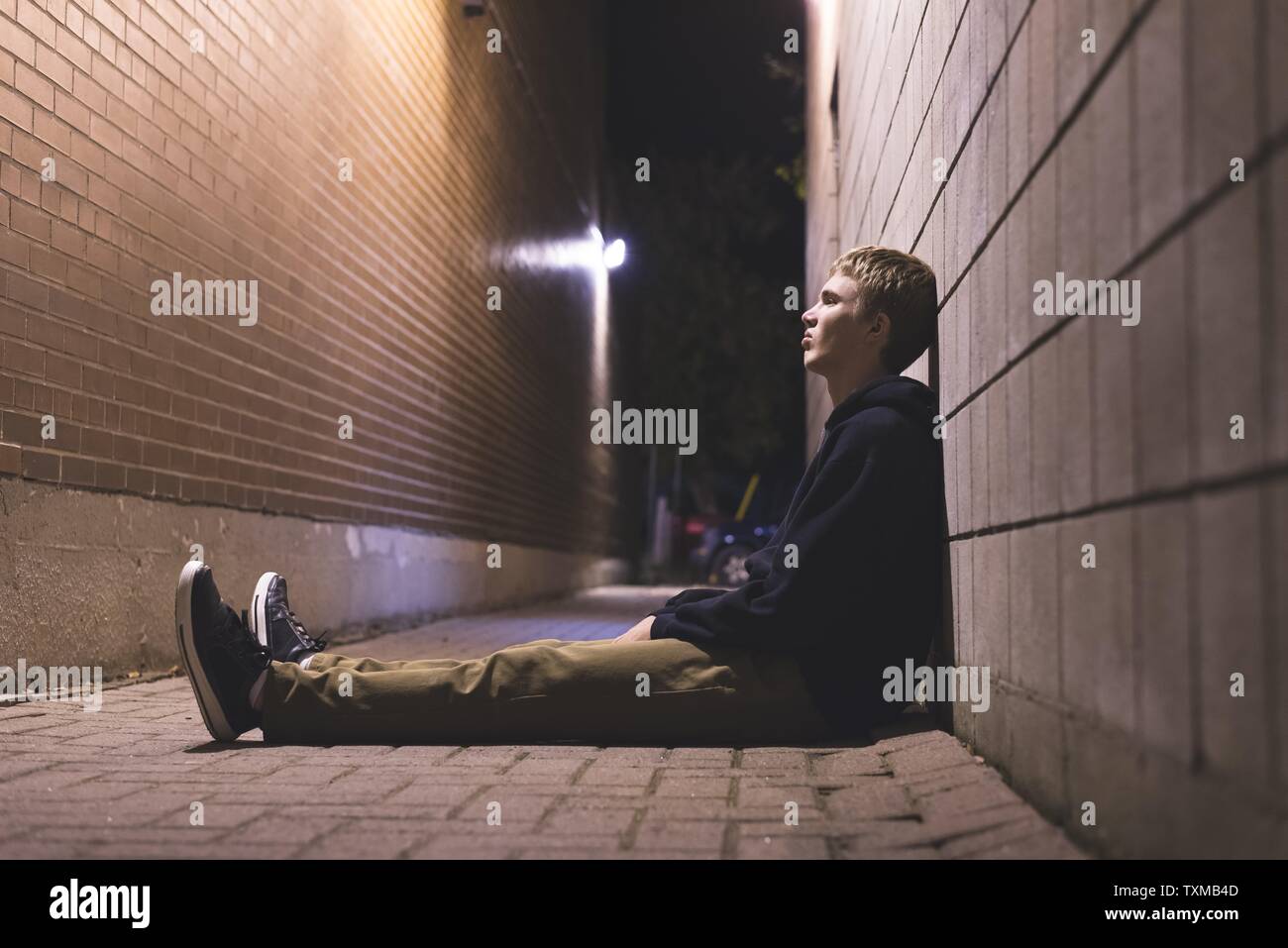 Lonely sitting street teen hi-res stock photography and images - Alamy