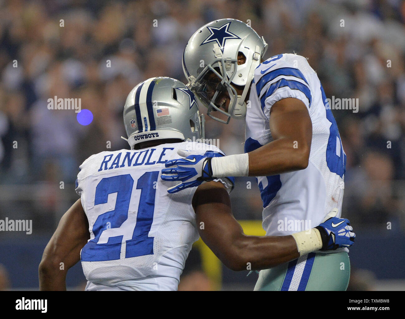 Dallas Cowboys Joseph Randle is congratulated by teammate Dez Bryant after Randle ran for a 1-yard touchdown against the Washington Redskins in the fourth quarter at AT&T Stadium in Arlington, Texas on October 13, 2013. UPI/Kevin Dietsch Stock Photo