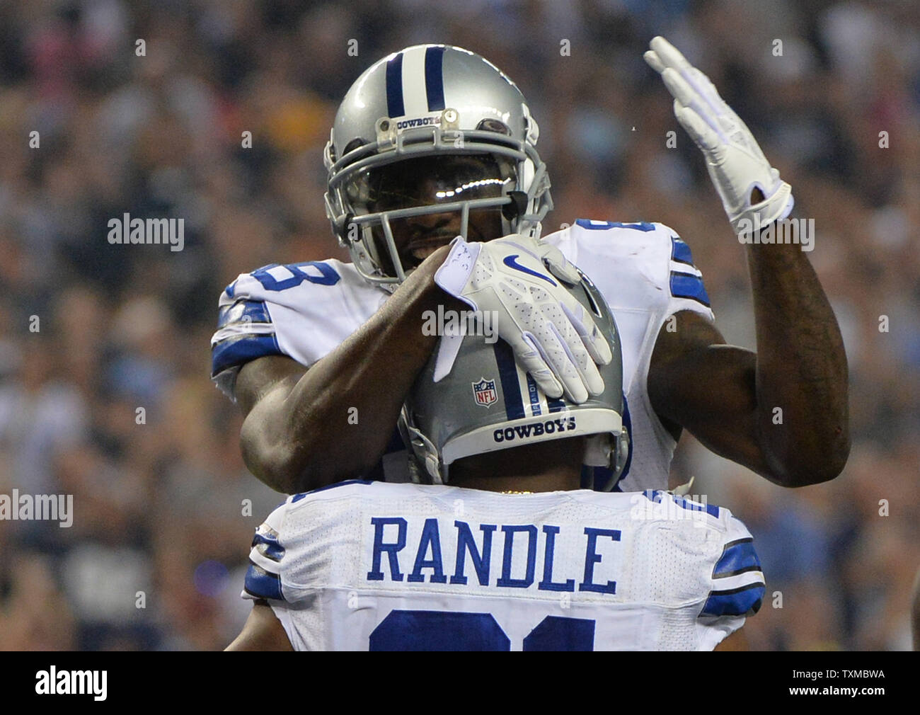 Dallas Cowboys Joseph Randle is congratulated by teammate Dez Bryant after Randle ran for a 1-yard touchdown against the Washington Redskins in the fourth quarter at AT&T Stadium in Arlington, Texas on October 13, 2013. UPI/Kevin Dietsch Stock Photo