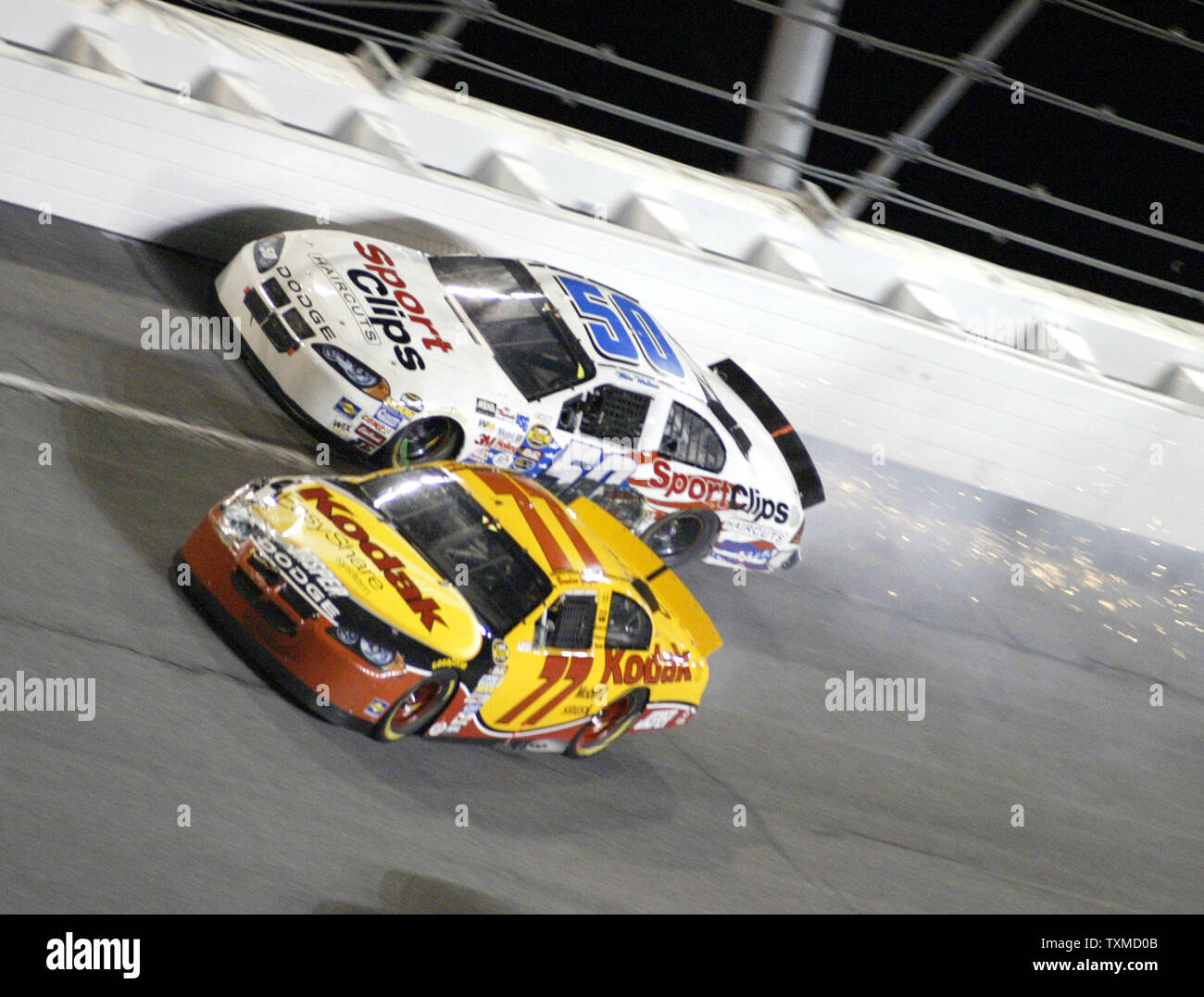 Brendan Gaughan(77) runs into Mike Wallace coming out of turn three
