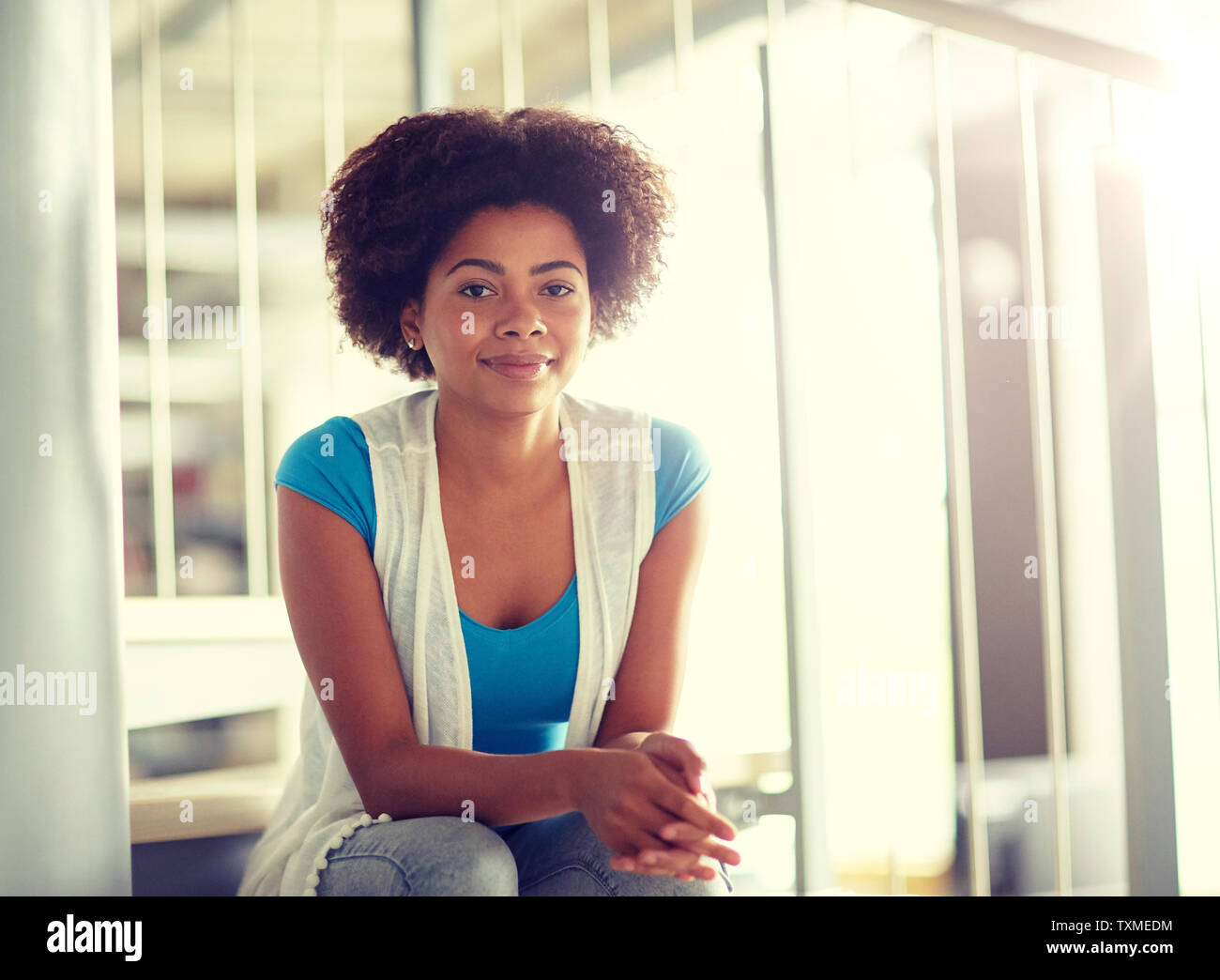 happy african student girl sitting on stairs Stock Photo - Alamy