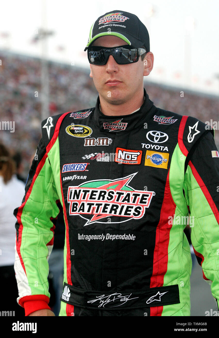 Kyle Busch walks to his car on pit road prior to the NASCAR Coke Zero ...