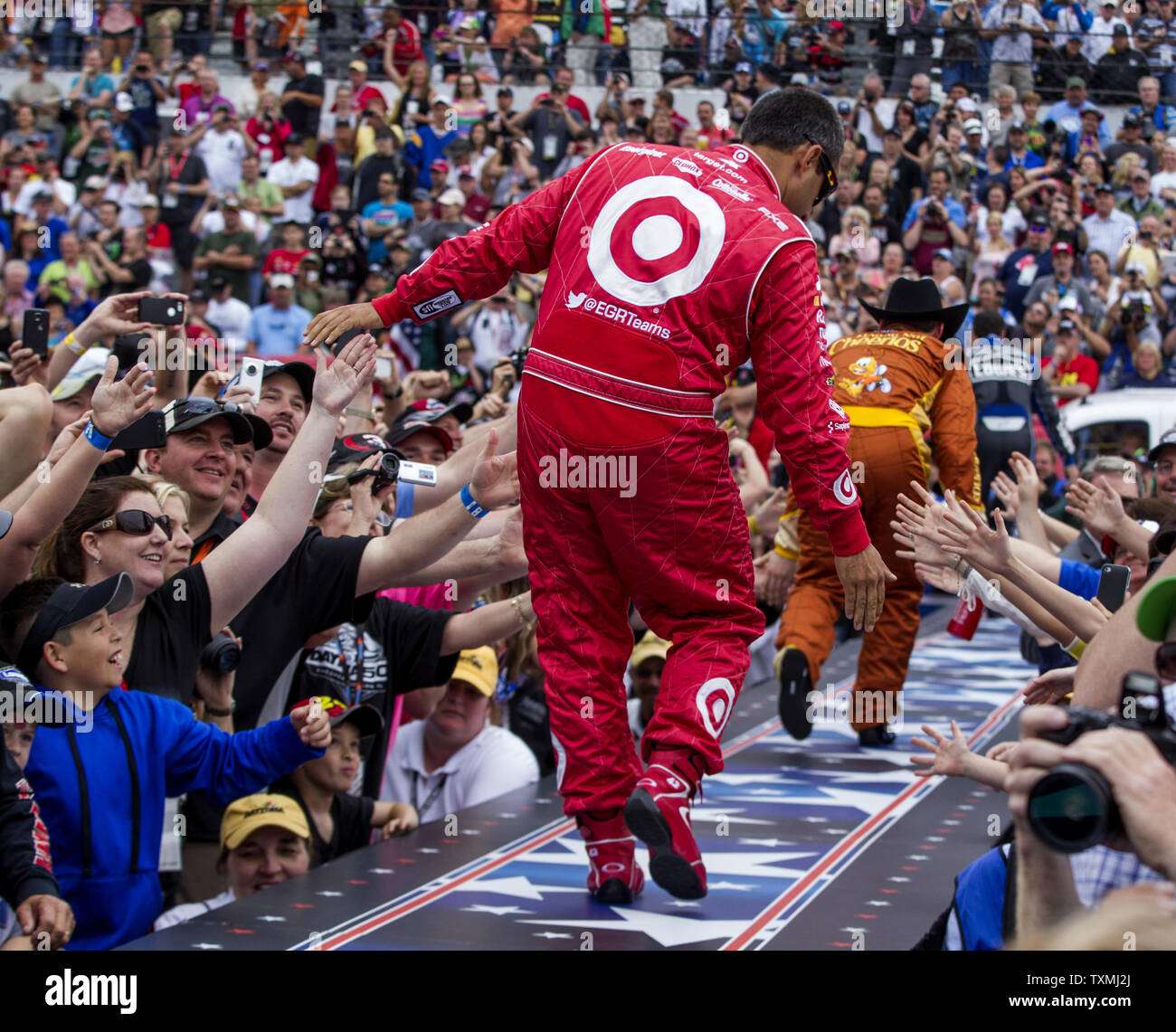 Juan Pablo Montoya, left, Austin Dillon, center, and  Jimmie Johnson touch hands with the fans during driver introductions prior to the start of the NASCAR Sprint Cup Series Daytona 500 auto race at Daytona International Speedway in Daytona Beach, Florida February 24, 2013.  UPI/Mark Wallheiser Stock Photo