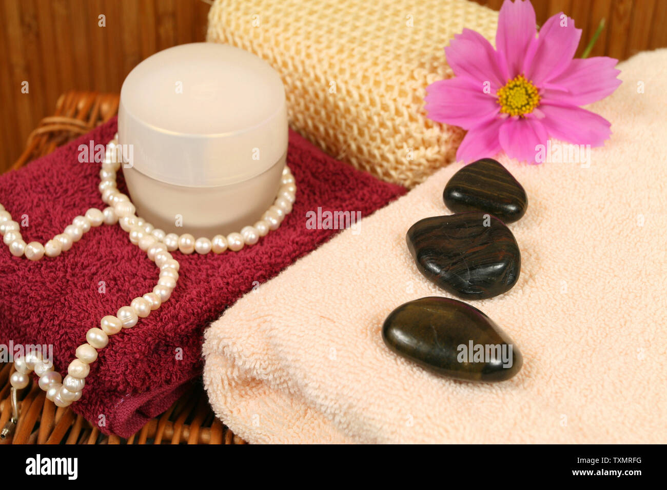 Towels, cream and pearls in  luxury spa therapy composition Stock Photo