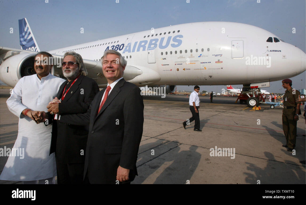Indian Civil Aviation Minister Praful Patel, (L), Kingfisher Airlines owner Vijay Mallya, (C) and Airbus Chief Operating Officer-Customers John Leahy pose in the backdrop of an Airbus A380, at the Indira Gandhi International Airport in New Delhi on May 7, 2007. The aircraft flew into Delhi previews day to carry out feasibility tests before flights begin.The first commercial A380 plane will roll out late this year or early next year. Airbus has already booked firm orders for over 150 planes from various airlines across the world, including India's Kingfisher Airlines.   (UPI Photo) Stock Photo