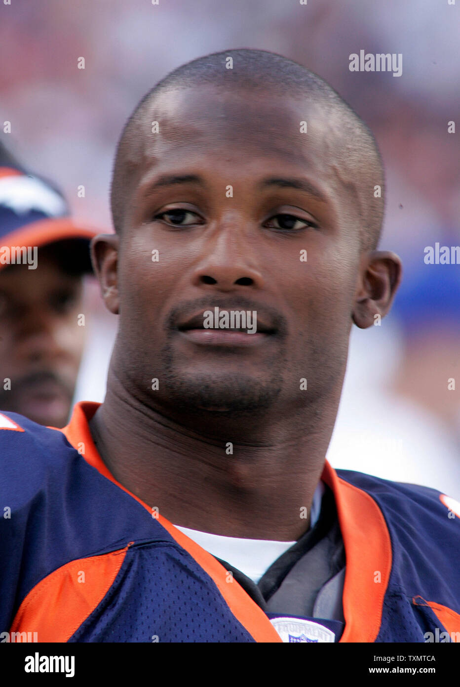 Denver's cornerback Champ Bailey kneels and grimaces in between