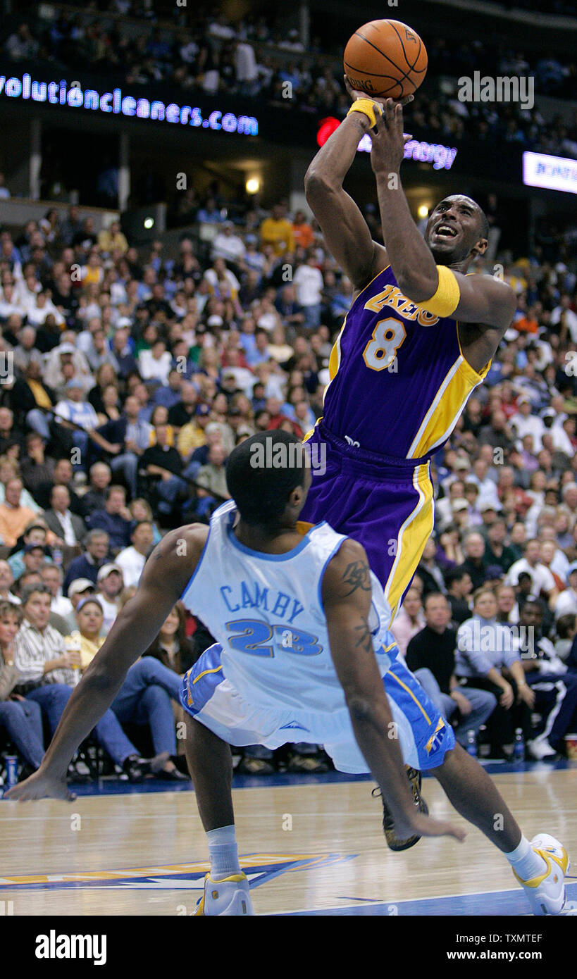Denver Nuggets center Marcus Camby (L) draws the foul from a charging Los Angeles Lakers guard Kobe Bryant (R) in the second quarter at the Pepsi Center in Denver November 2, 2005.  (UPI Photo/Gary C. Caskey Stock Photo