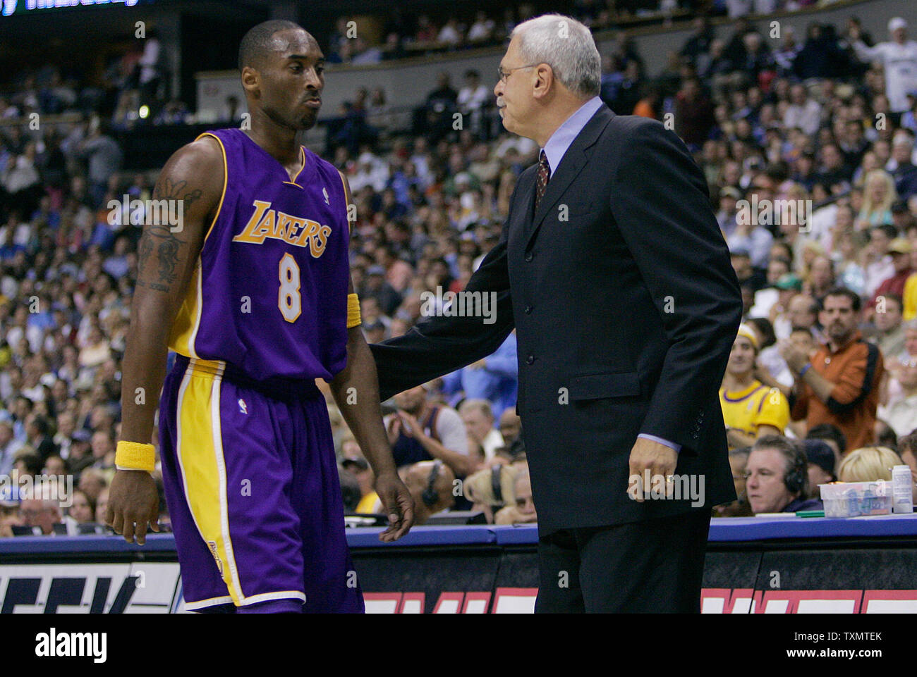 Los Angeles Lakers guard Kobe Bryant (L) is taken out of the game by head coach Phil Jackson (R) late in the second quarter at the Pepsi Center in Denver November 2, 2005.  Bryant and Jackson begin a new season together again.    (UPI Photo/Gary C. Caskey) Stock Photo