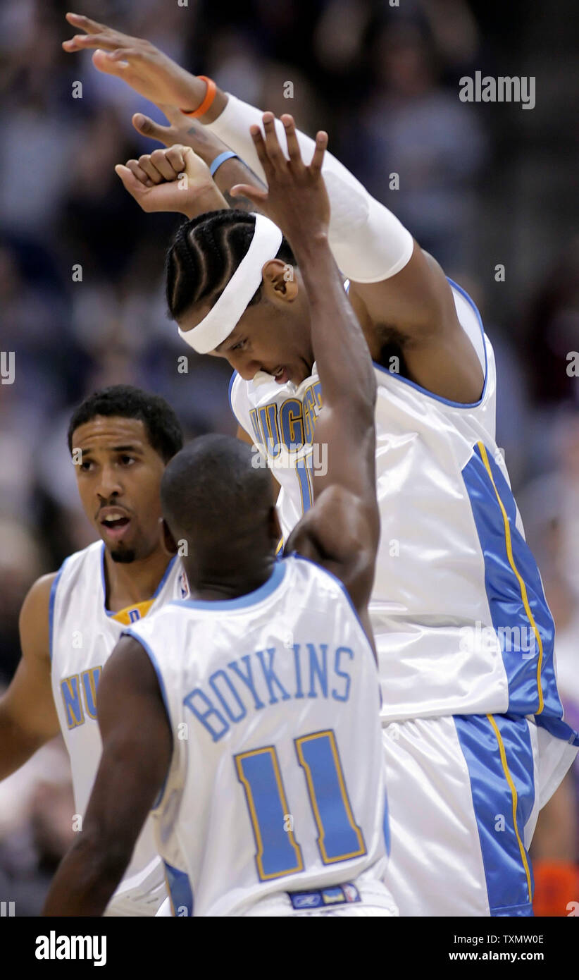 Denver Nuggets guard Earl Boykins (C) congratulates teammate Carmelo Anthony (R) after his game-winning shot in triple overtime against the Phoenix Suns at Pepsi Center in Denver, Colorado January 10, 2006.  Nuggets guard Andre Miller closes in on the celebrating duo.  Denver beat Phoenix 139-137 in triple overtime.  Anthony led all scorers with 43 points.  (UPI Photo/Gary C. Caskey) Stock Photo