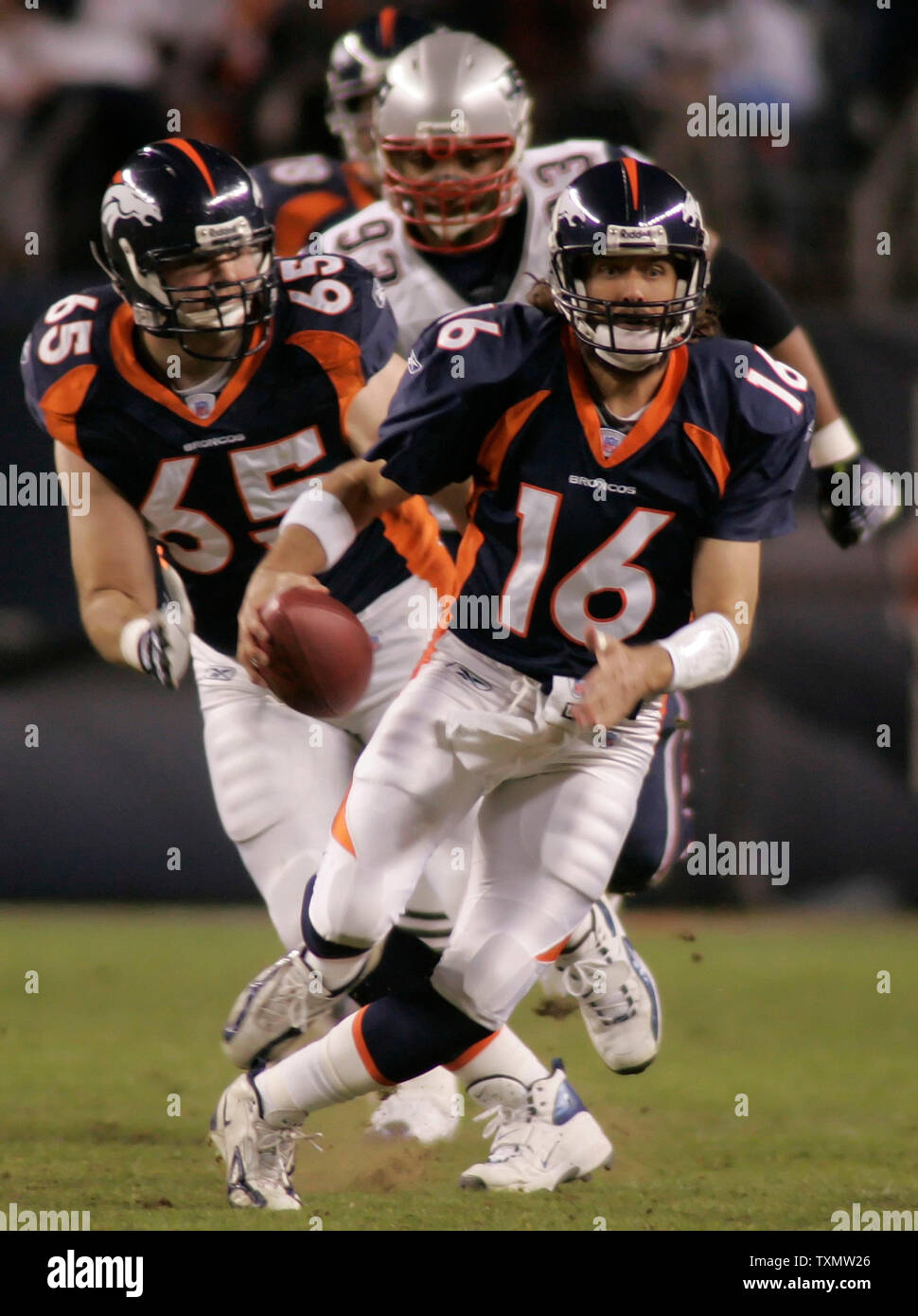 Denver Broncos quarterback Jake Plummer (C) follows his right and left  guards Cooper Carlisle (L) and Ben Hamilton (R) on a one-yard touchdown run  against the Indianapolis Colts, left tackle Anthony McFarland (