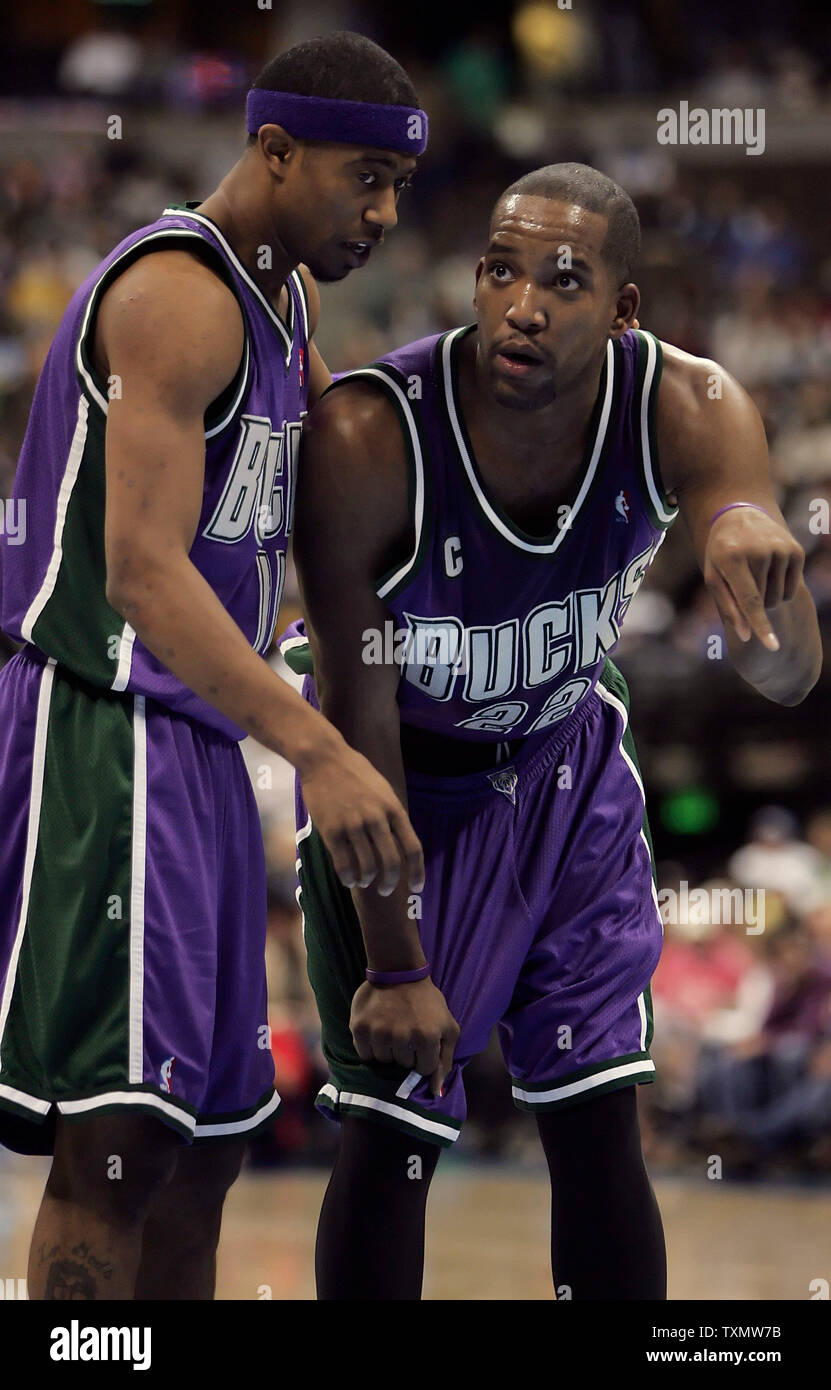 Milwaukee Bucks teammates T.J. Ford (L) and Michael Redd (R) confer on the free throw line in the fourth quarter against the Denver Nuggets at the Pepsi Center in Denver February 27, 2006.  Redd led all scorers with 24 points as Milwaukee beat Denver 110-89.   (UPI Photo/Gary C. Caskey) Stock Photo