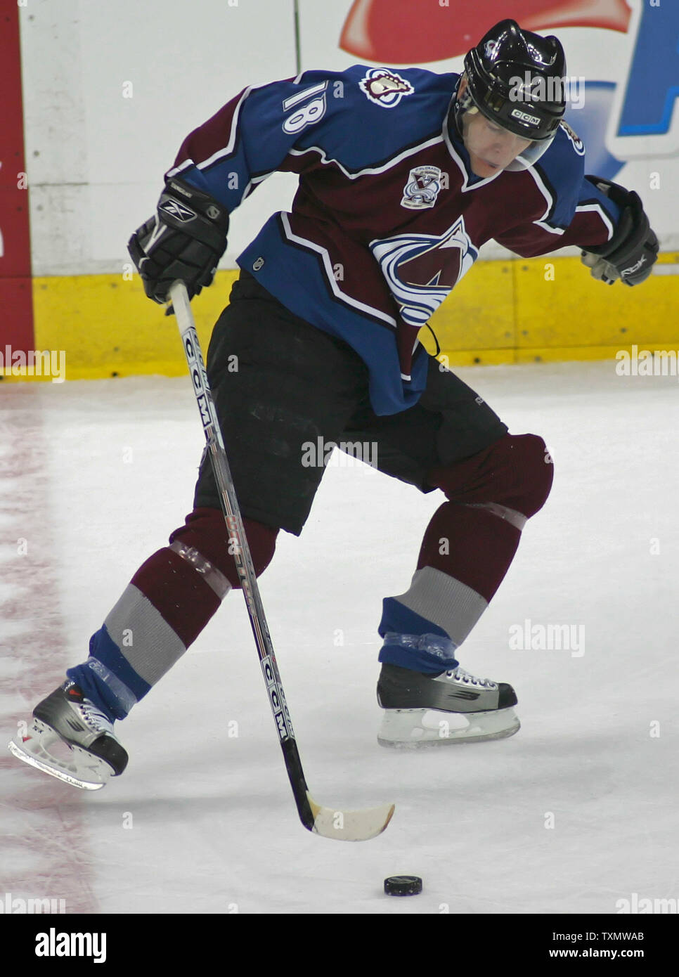 Colorado Avalanche left wing Alex Tanguay gathers in the puck against the  Calgary Flames at the Pepsi Center in Denver March 12, 2006. Tanguay scored  a goal and an assist in the