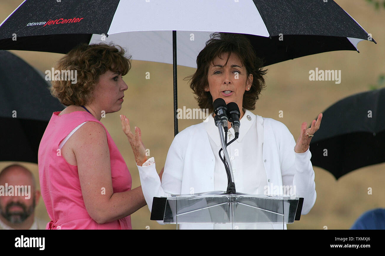 Dawn Anna Beck (R), mother to Columbine victim Lauren Townsend, speaks to the audience as a thunder storm passes through at the official Columbine memorial groundbreaking ceremony at Clement Park in Littleton, Colorado June 16, 2006.  Former President Bill Clinton spoke at the groundbreaking ceremony to help raise the remaining money for the $1.5 million dollar memorial.  The Columbine memorial will be at the base of Rebel hill near Columbine high school where on April 20, 1999, Dylan Klebold and Eric Harris terrorized the school killing one teacher and twelve students before taking their own Stock Photo