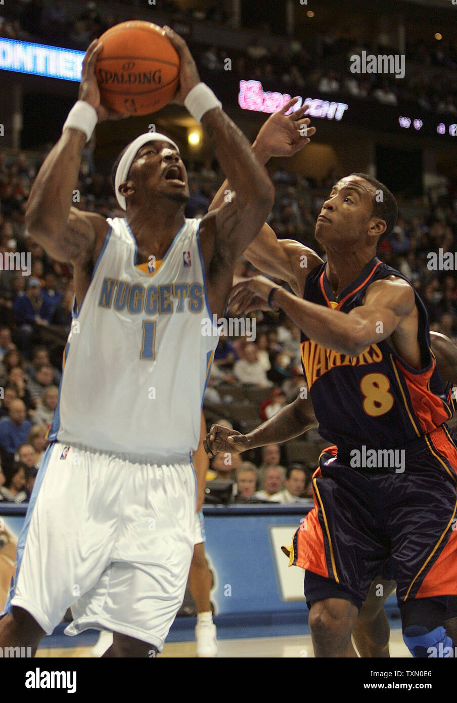 Denver Nuggets J.R. Smith (L) drives against Golden State Warriors Monta Ellis (R) in the first half of the game at the Pepsi Center in Denver on November 24, 2006. Smith scored 31 points. Denver beat Golden State 140-129.  (UPI Photo/Gary C. Caskey) Stock Photo