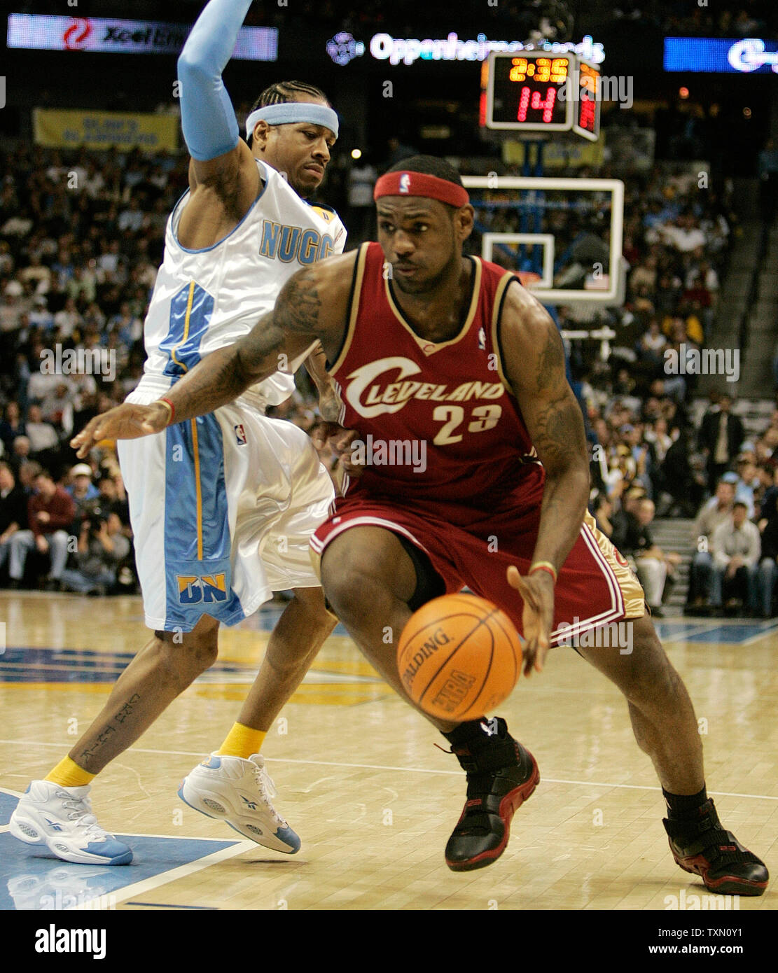 Cleveland Cavaliers guard/forward LeBron James (R) glides past Denver Nuggets guard Allen Iverson (L) in the first quarter at the Pepsi Center in Denver January 19, 2007.   (UPI Photo/Gary C. Caskey) Stock Photo