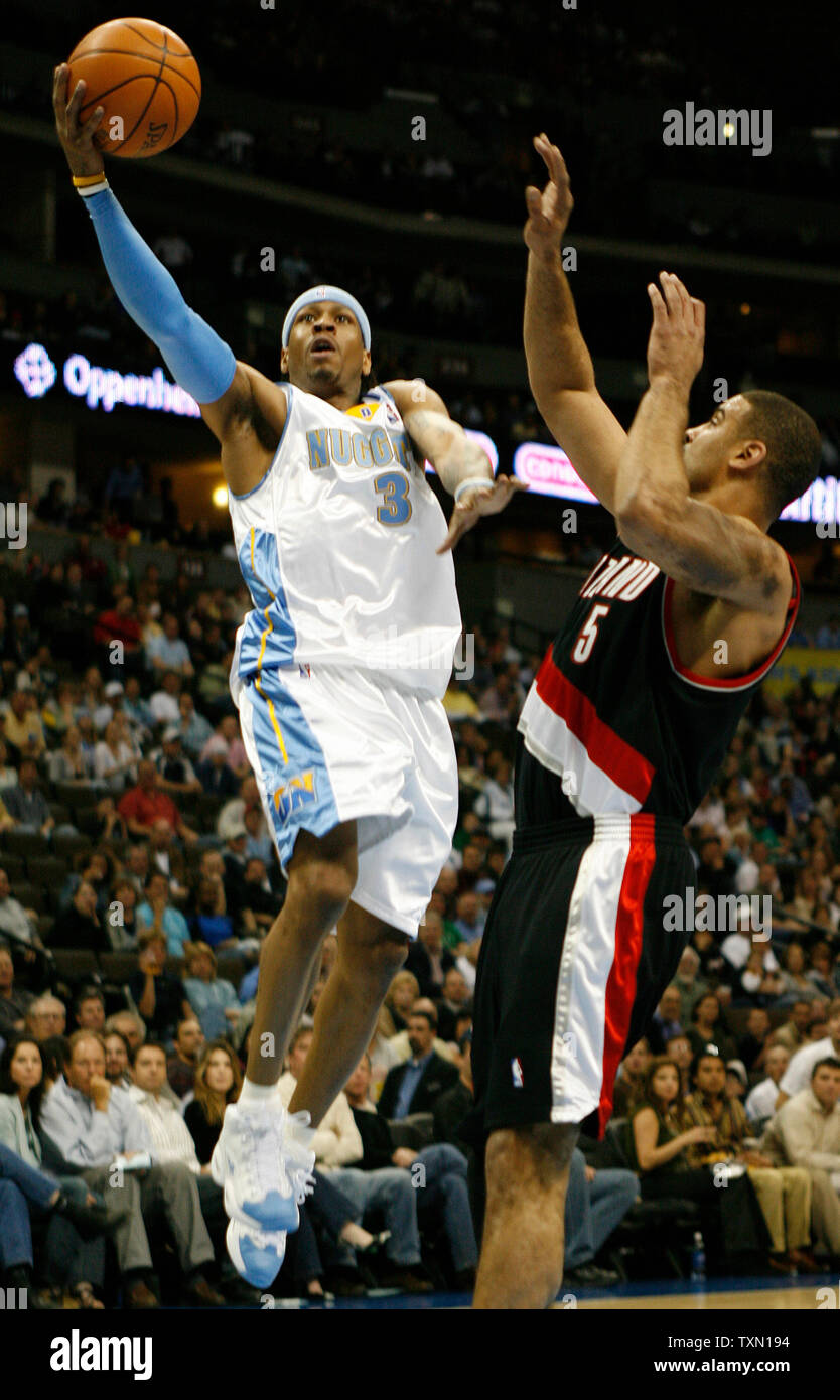 Denver Nuggets guard Allen Iverson (L) scores against Portland Trail Blazers Ime Udoka during the first quarter at the Pepsi Center in Denver on March 13,2007.  Iverson scored a game-high 31 points leading Denver over Portland 107-99.  (UPI Photo/Gary C. Caskey) Stock Photo