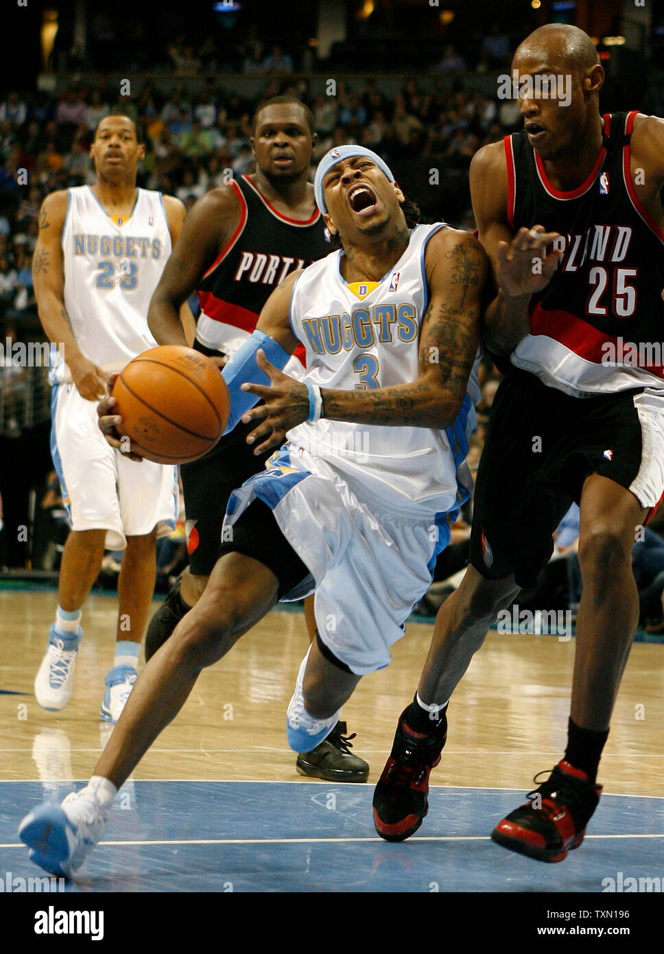 Denver Nuggets guard Allen Iverson (C) scores against Portland Trail  Blazers Brandon Roy (R) during the second half at the Pepsi Center in  Denver on March 13, 2007. Nuggets Marcus Camby (L)