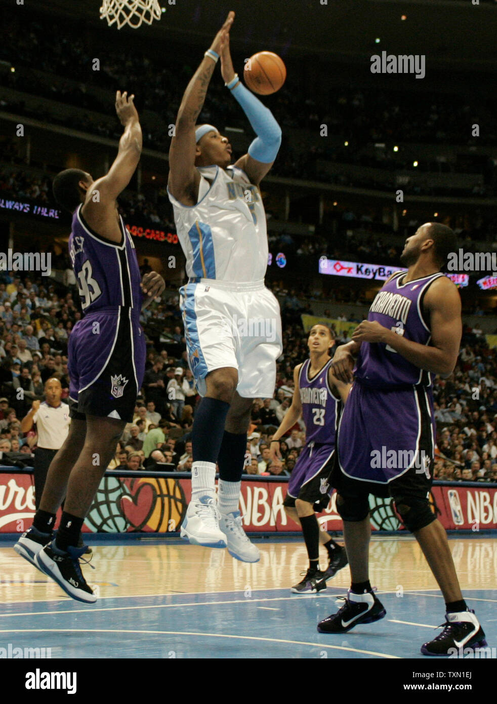 Sacramento Kings forward Ron Artest (L) tips the ball away from Denver Nuggets forward Carmelo Anthony (C) during the first quarter at the Pepsi Center in Denver on April 4, 2007.  Kings Shareef ABdur-Rahim (R)  and Kevin Martin watch the play.   (UPI Photo/Gary C. Caskey) Stock Photo