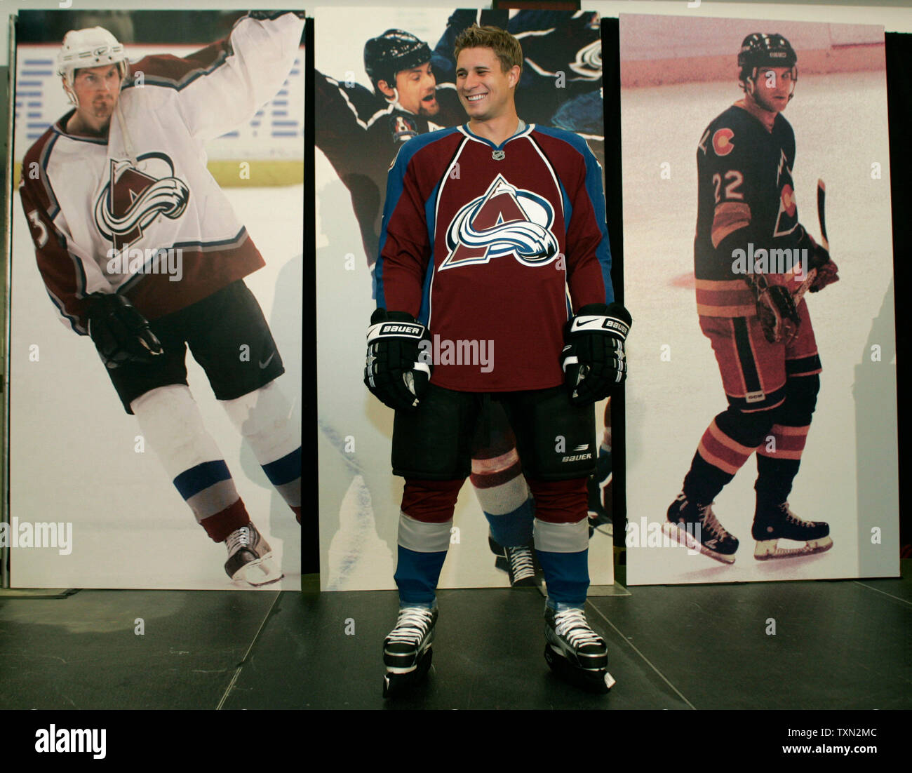 Colorado Avalanche Defenseman John Michael Liles Models The New Avalanche Reebok Designed Uniform Against The Background Of Past Uniforms During A Press Conference At The Pepsi Center In Denver On September 12 2007