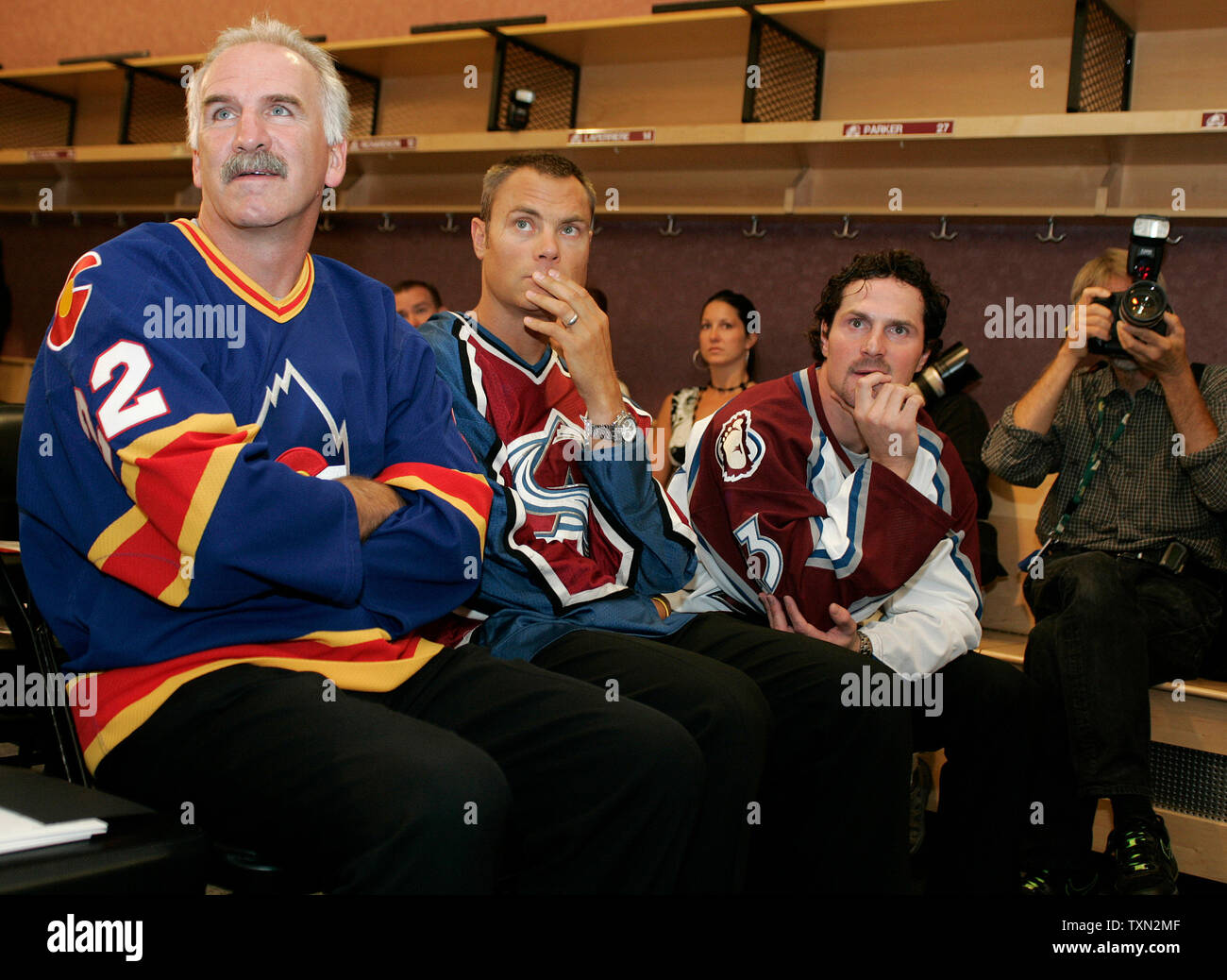 (L-R) Colorado Avalanche head coach Joel Quenneville, former Avalanche Curtis Leschyshyn, and Avalanche forward Milan Hejduk watch the unveiling of the new Avalanche uniform during a press conference at the Pepsi Center in Denver on September 12, 2007.  Quenneville, Leschyshyn, and Hejduk each wore a previous generation of hockey jersey for the presentation.   The new uniforms by Reebok will improve player performance and safety.  (UPI Photo/Gary C. Caskey) Stock Photo