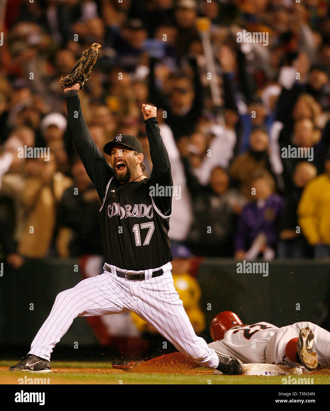 Colorado Rockies first baseman Todd Helton (L) celebrates after making the  final out against Arizona Diamondbacks left fielder Eric Byrnes during game  four of the National League Championship Series at Coors Field