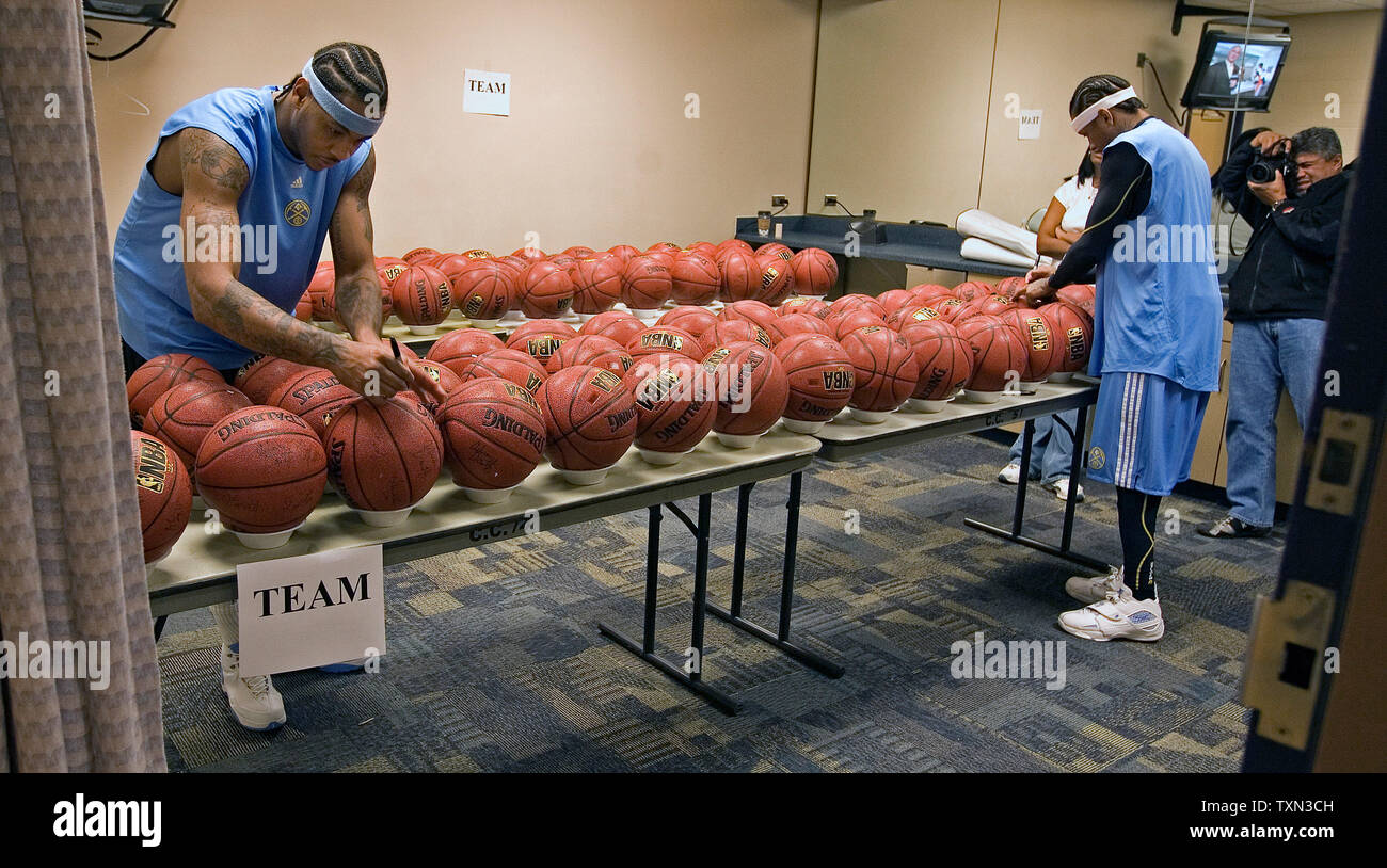 Denver Nuggets star forward Carmelo Anthony (L) and guard Allen Iverson sign team NBA basketballs after a practice session at the Pepsi Center in Denver on November 13, 2007.  (UPI Photo/Gary C. Caskey) Stock Photo