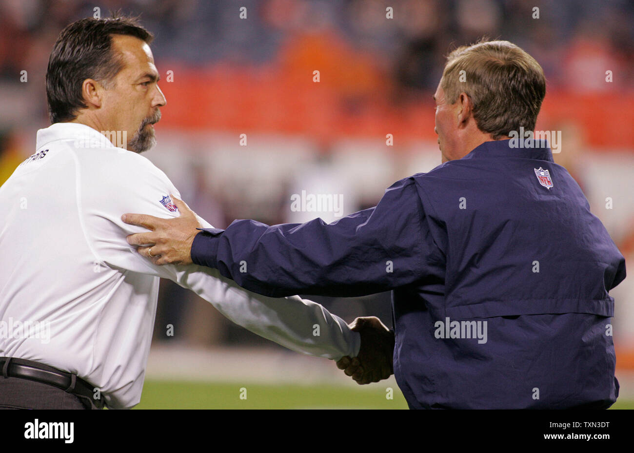 Tennessee Titans head coach Jeff Fisher (L) shakes hands with Denver Broncos head coach Mike Shanahan before their game at Invesco Field at Mile High in Denver on November 19, 2007.  (UPI Photo/Gary C. Caskey) Stock Photo