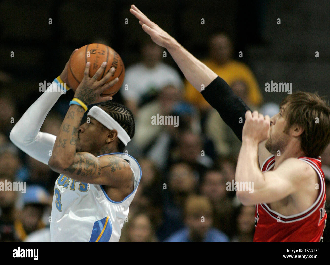 Chicago Bulls forward Andres Nocioni (R) of Argentina attempts to block shot by Denver Nuggets guard Allen Iverson during the first quarter at the Pepsi Center in Denver on November 20, 2007.   (UPI Photo/Gary C. Caskey) Stock Photo