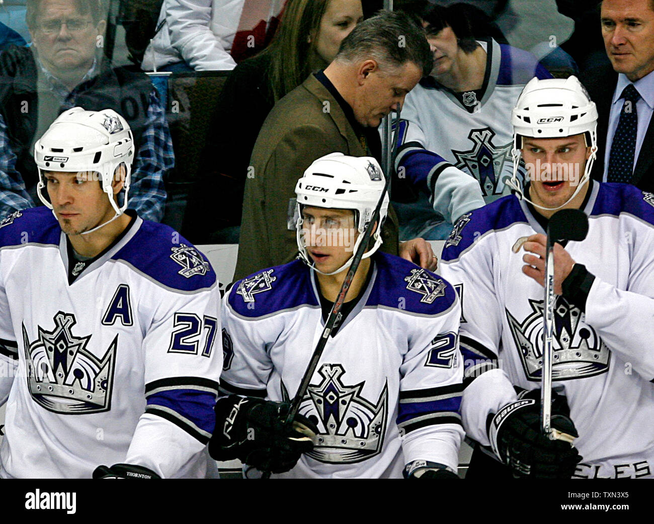 Los Angeles Kings head coach Marc Crawford paces behind Kings (L-R) Scott  Thornton, Jeff Giuliano, and Raitis Ivanans during the second period at the  Pepsi Center in Denver on December 29, 2007. (