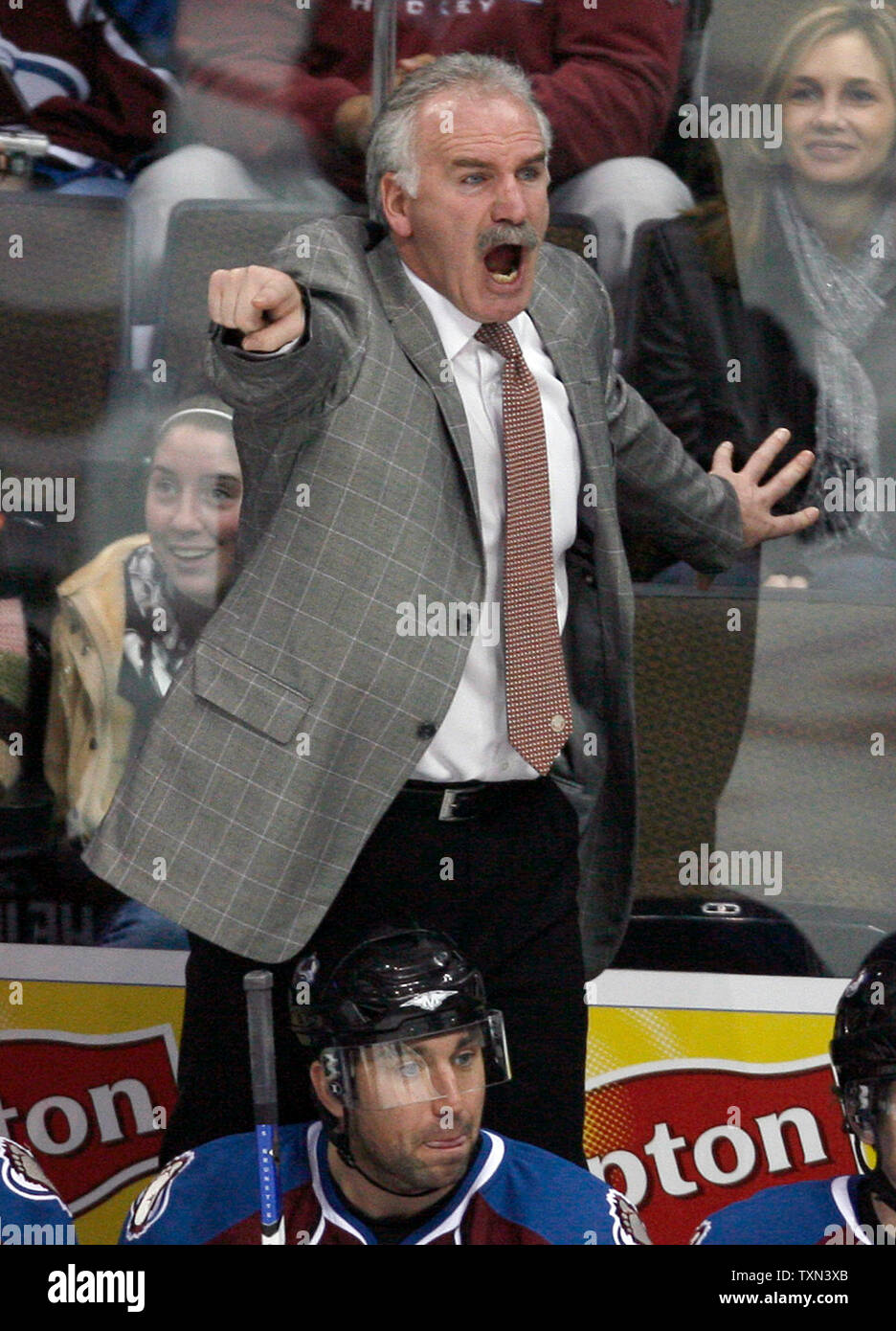 Colorado Avalanche head coach Joel Quenneville (R) wears his old