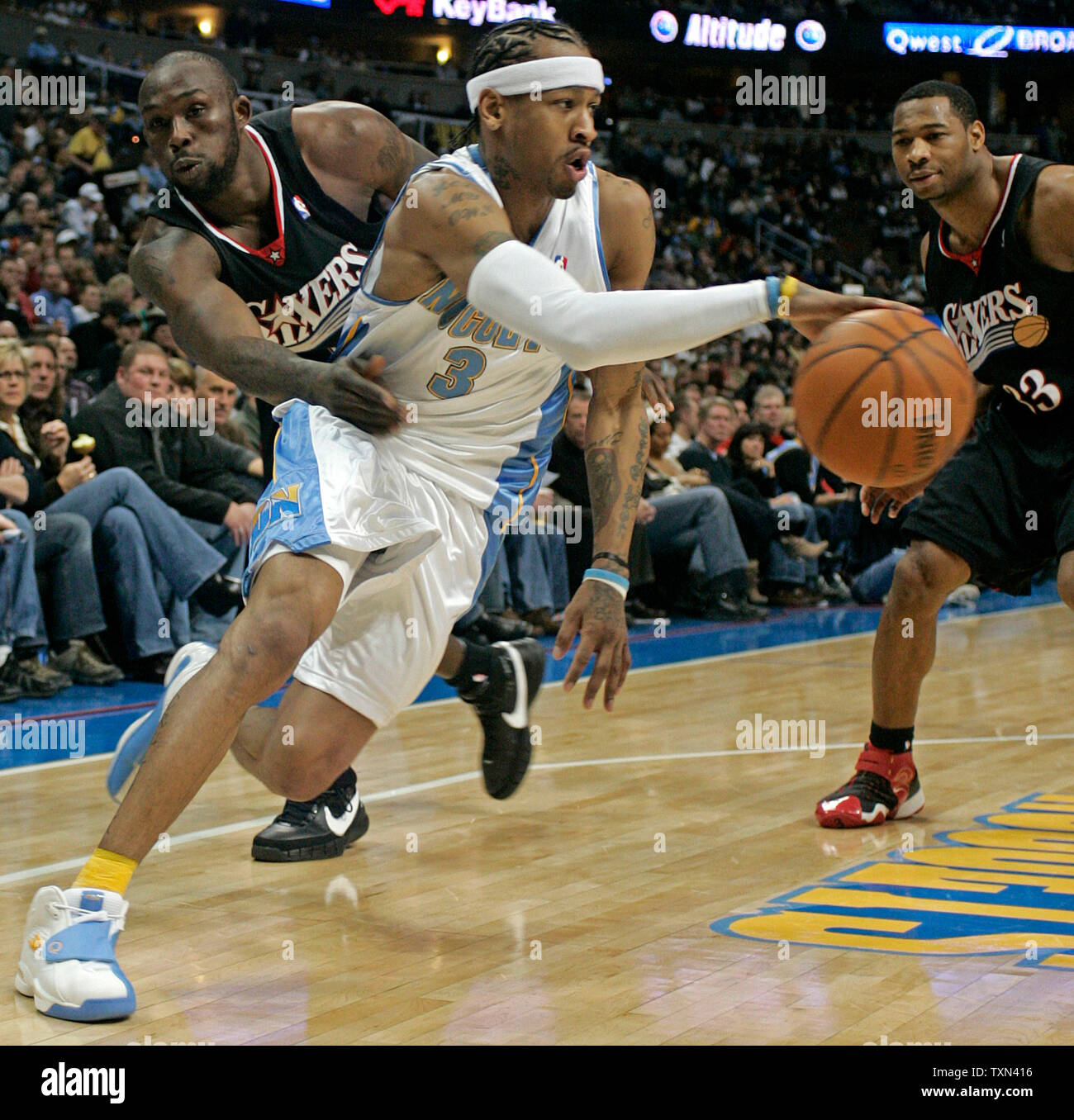 Denver Nuggets guard Allen Iverson (C) drives past Philadelphia 76ers guard  Willie Green (33) and forward Andre Iguodala during the first quarter at  the Pepsi Center in Denver on January 6, 2008. (
