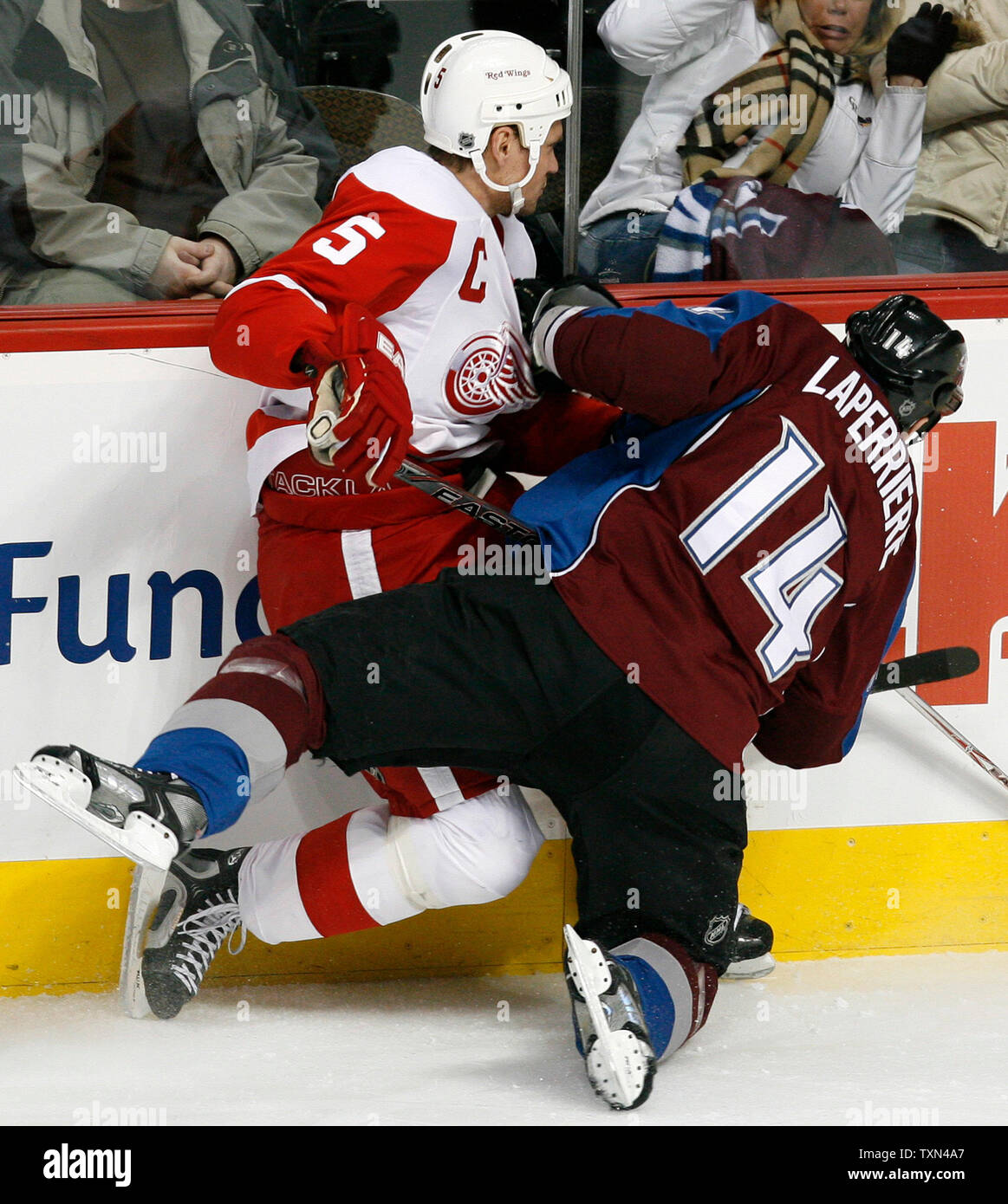 Colorado Avalanche right wing Ian Laperriere (R) checks Detroit Red Wings  defenseman Nicklas Lidstrom into the boards during the first period at the  Pepsi Center in Denver on February 18, 2008. Lidstrom
