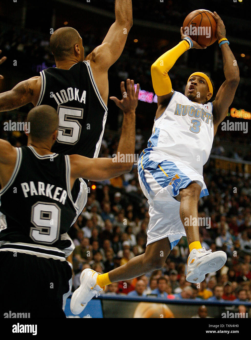 Denver Nuggets guard Allen Iverson (3) shoots over San Antonio Spurs Ime Udoka (C) and Tony Parker during the second quarter at the Pepsi Center in Denver on March 7, 2008.    (UPI Photo/Gary C. Caskey) Stock Photo