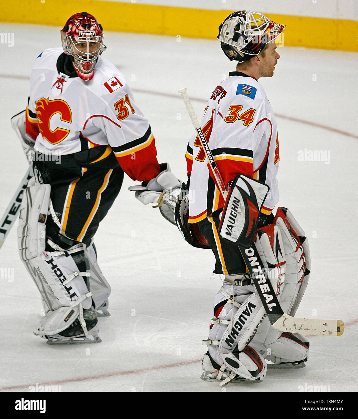 Calgary Flames starting goalie Miikka Kiprusoff (R) of Finland skates off  the ice after being replaced against the Colorado Avalanche during the  third period at the Pepsi Center in Denver on March