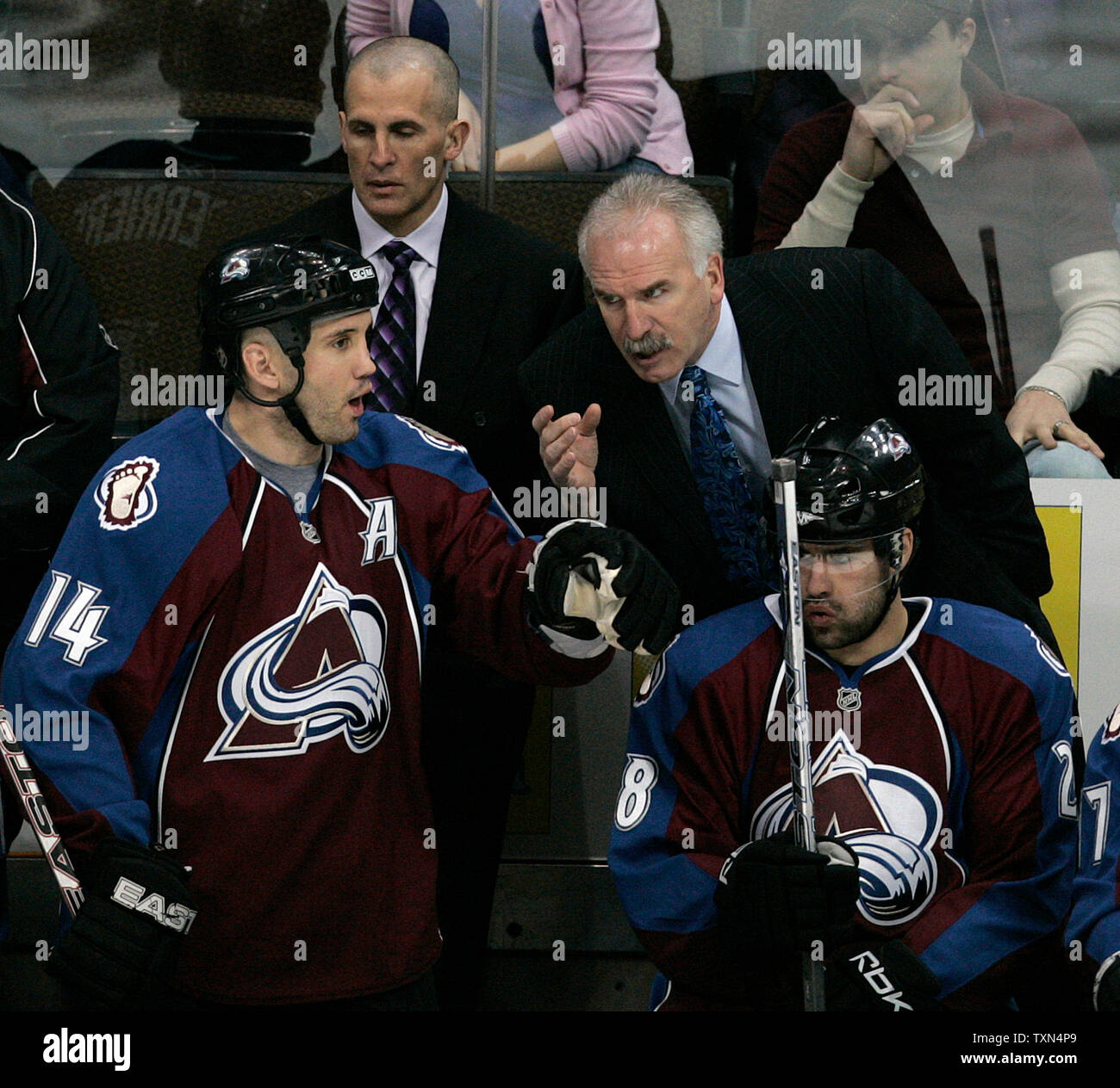 Colorado Avalanche head coach Joel Quenneville (top right) gestures toward Avalanche right wing Ian Laperriere (14) during the first period at the Pepsi Center in Denver on March 14, 2008.  Colorado leads the Northwest division while New Jersey, the Atlantic division leader, sits atop the Eastern Conference standings.  (UPI Photo/Gary C. Caskey) Stock Photo