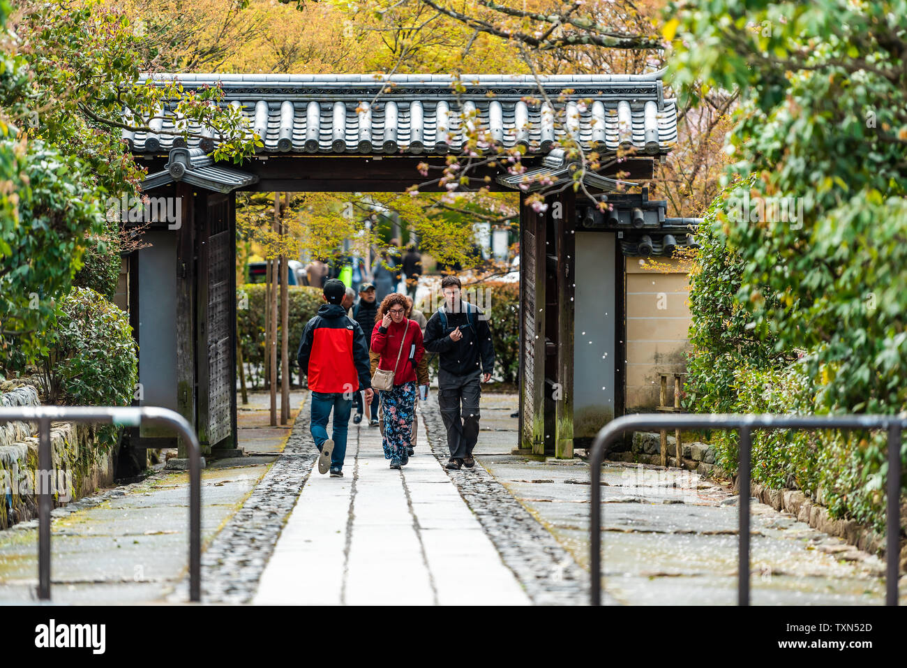 Kyoto, Japan - April 10, 2019: Ryoanji temple entrance or exit with people walking in spring Stock Photo