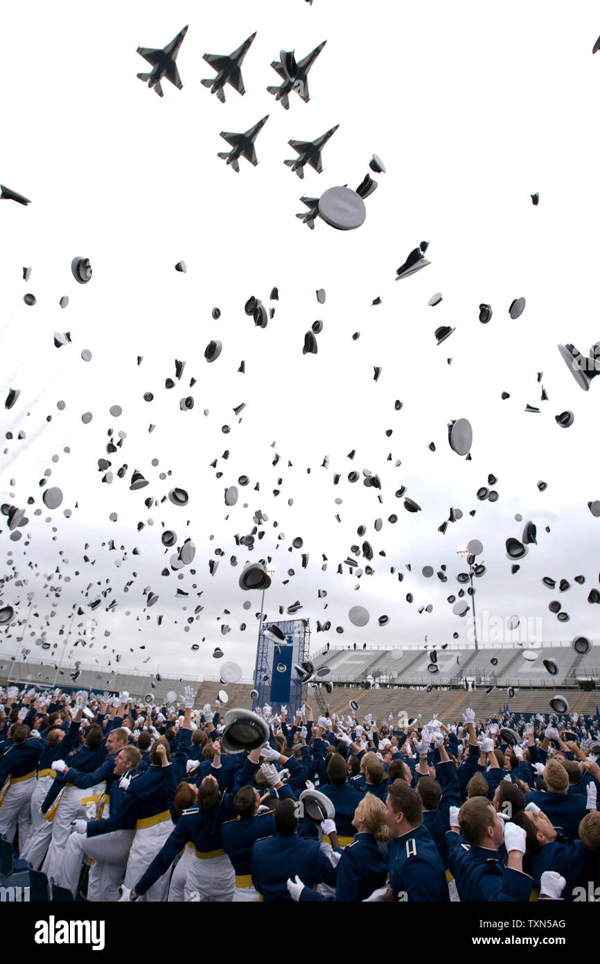 Graduating cadets throw their caps into the air as the Air Force