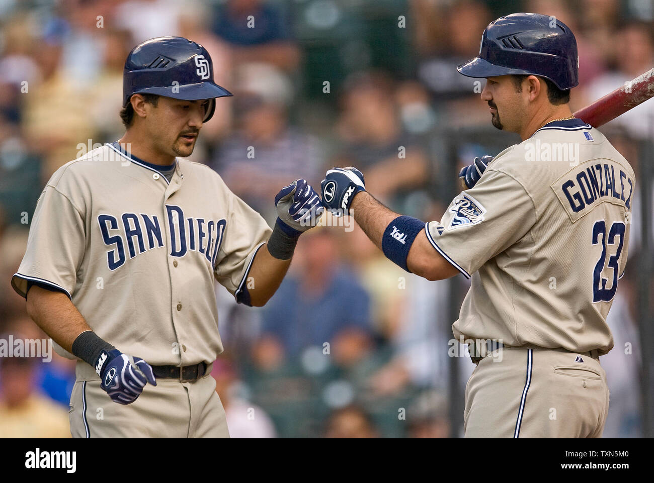 San Diego Padres first baseman Adrian Gonzalez, right, and his brother and  fellow teammate third baseman Edgar Gonzalez, left, during a spring  training baseball game against the Arizona Diamondbacks in Peoria, Ariz.