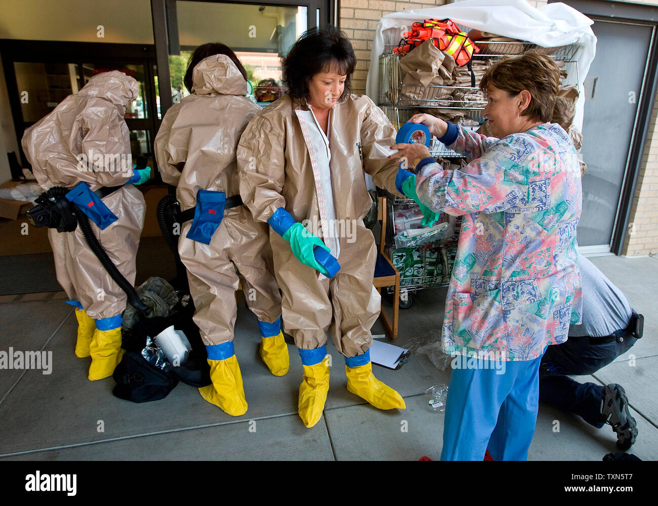 Nurses Suit Up In Decontamination Gear Just Before Victims