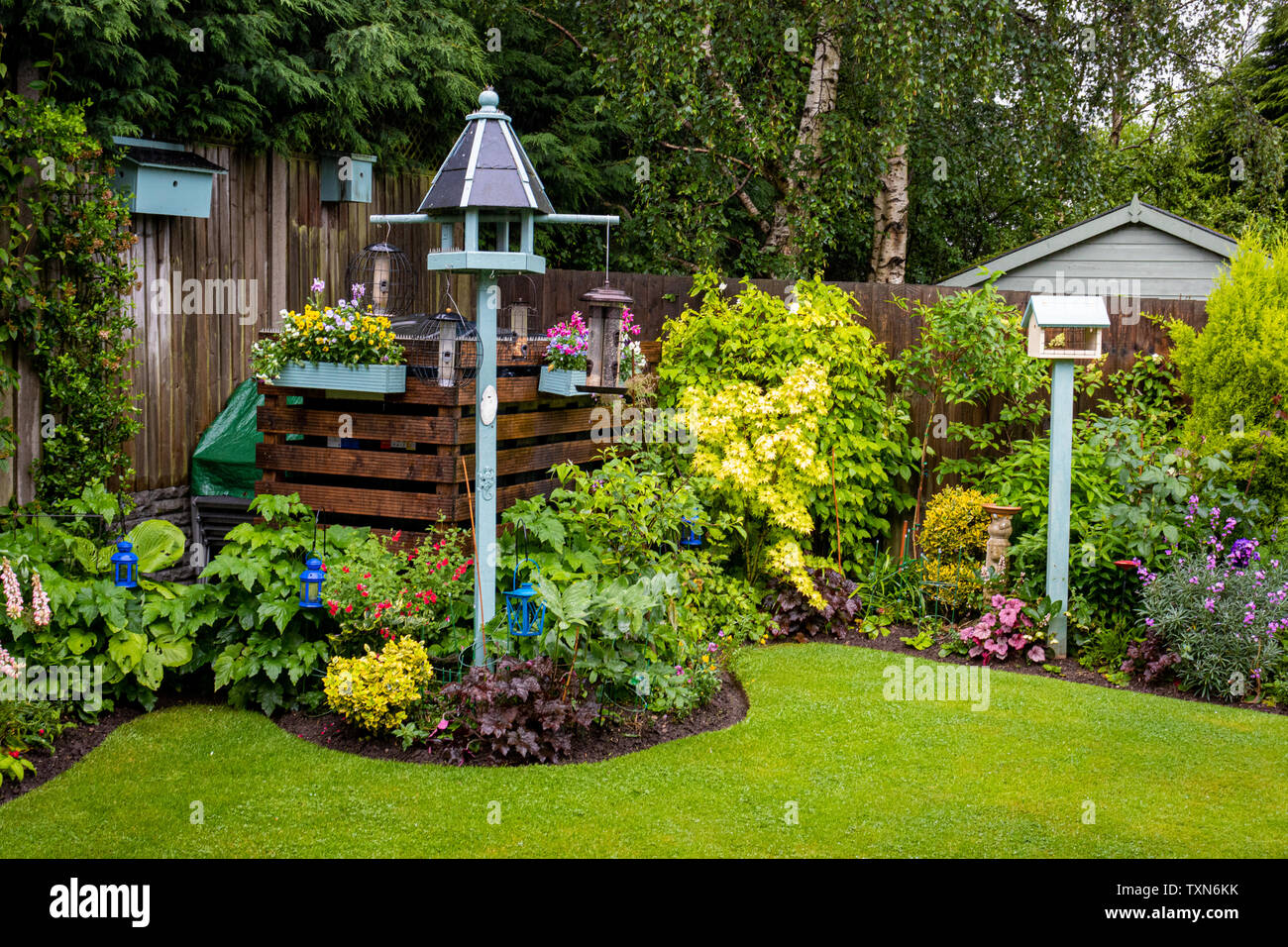 A Pretty Area Of A Urban Garden With Bird Feeding Stations And