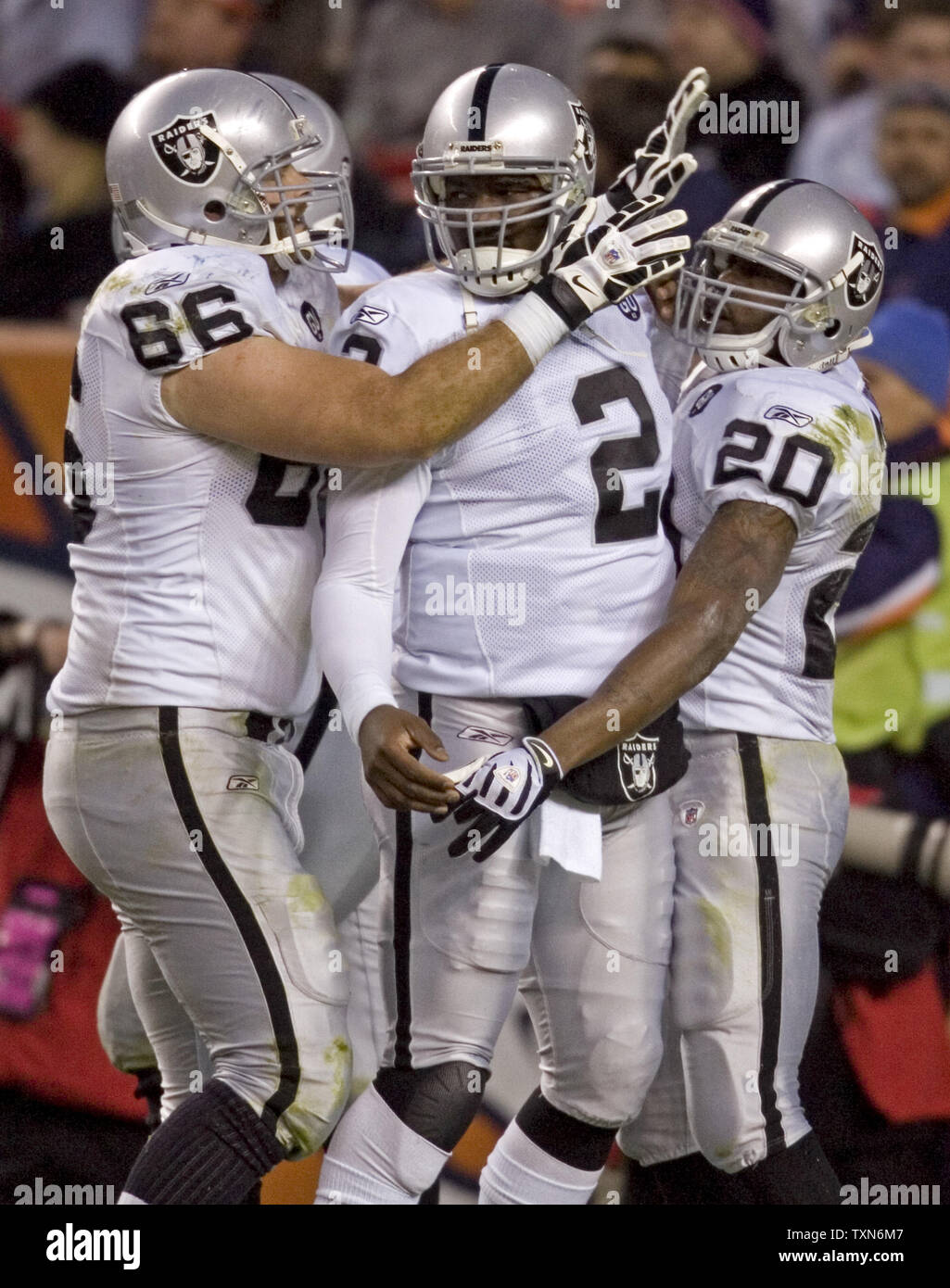 Oakland Raiders guard Cooper Carlisle (66) congratulates quarterback JaMarcus Russell (2) and running back Darren McFadden after McFadden's one-yard touchdown run in the fourth quarter against the Denver Broncos at Invesco Field at Mile High in Denver on November 23, 2008. Oakland defeated the AFC West division leader Denver Broncos 31-10.      (UPI Photo/ Gary C. Caskey) Stock Photo