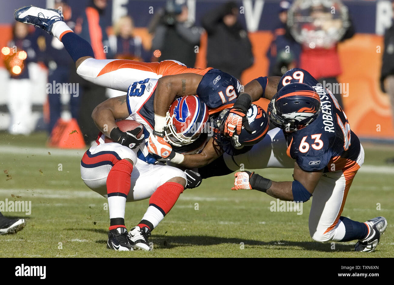 Denver Broncos linebacker Jamie Winborn and defensive tackle Dewayne Robertson bring down Buffalo Bills running back Marshawn Lynch during the first half at Invesco Field at Mile High in Denver on December 21, 2008.    (UPI Photo/Gary C. Caskey) Stock Photo